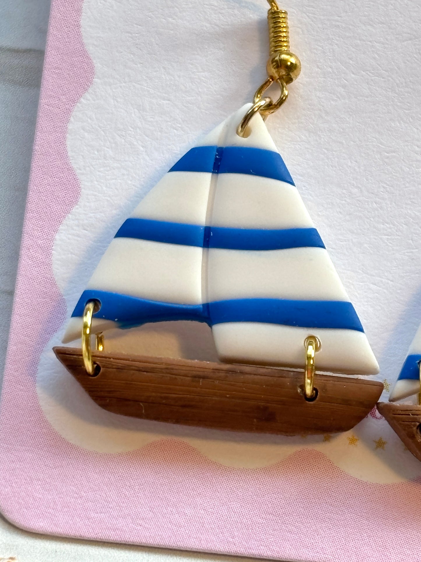 closeup nautical sailboat dangle earring striped polymer clay detail handcrafted summer marine jewelry with gold hook