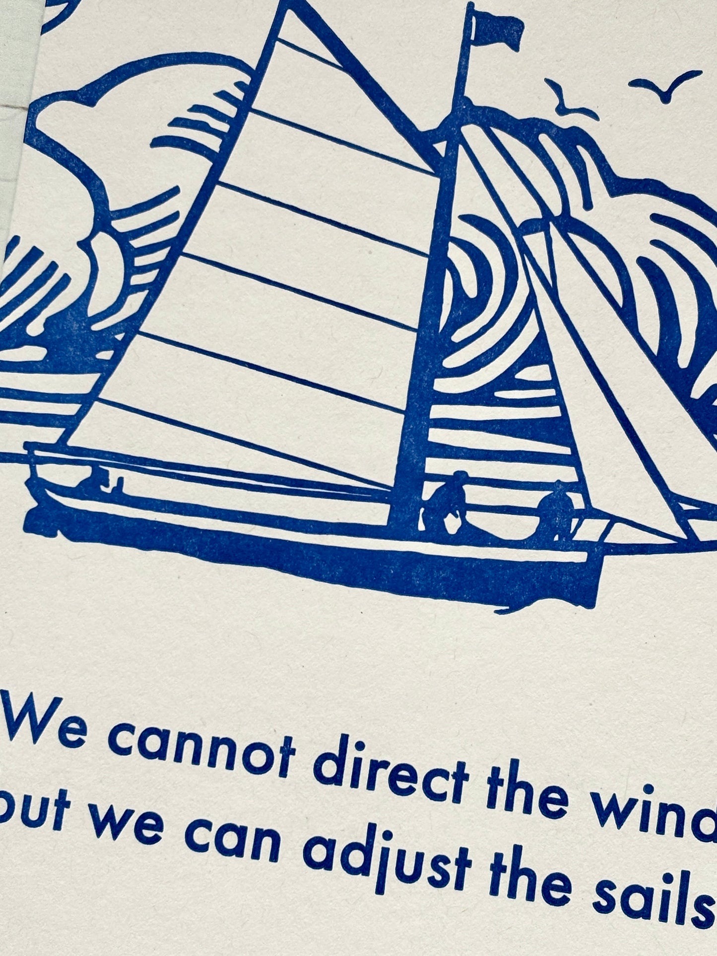 closeup shot of blue sailboat graphic quote card nautical themed greeting for wisdom and resilience letterpress style inspirational print