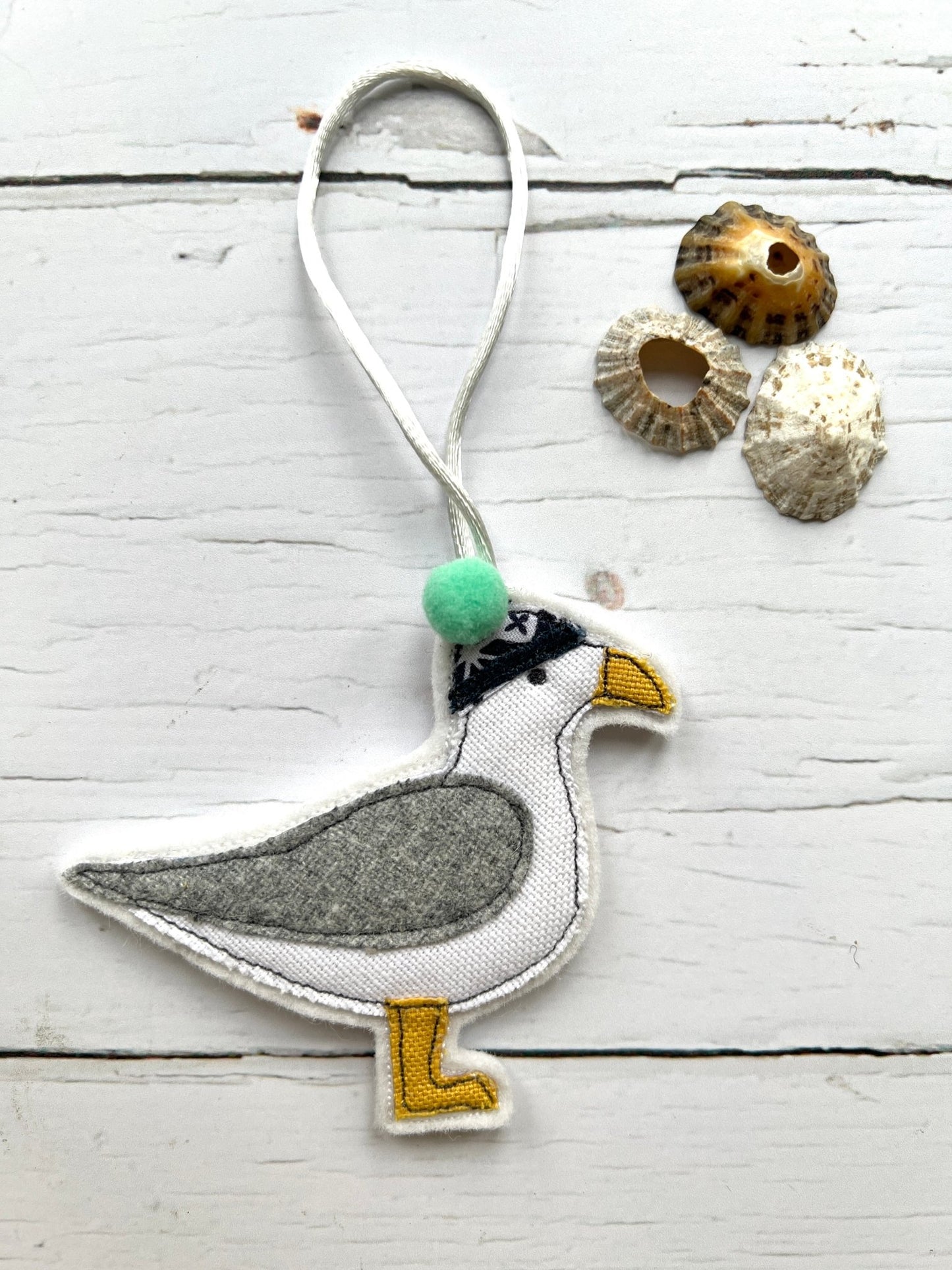 fabric seagull wearing beanie ornament, quirky coastal bird charm, handcrafted pompom decoration, nautical hanging decor gift