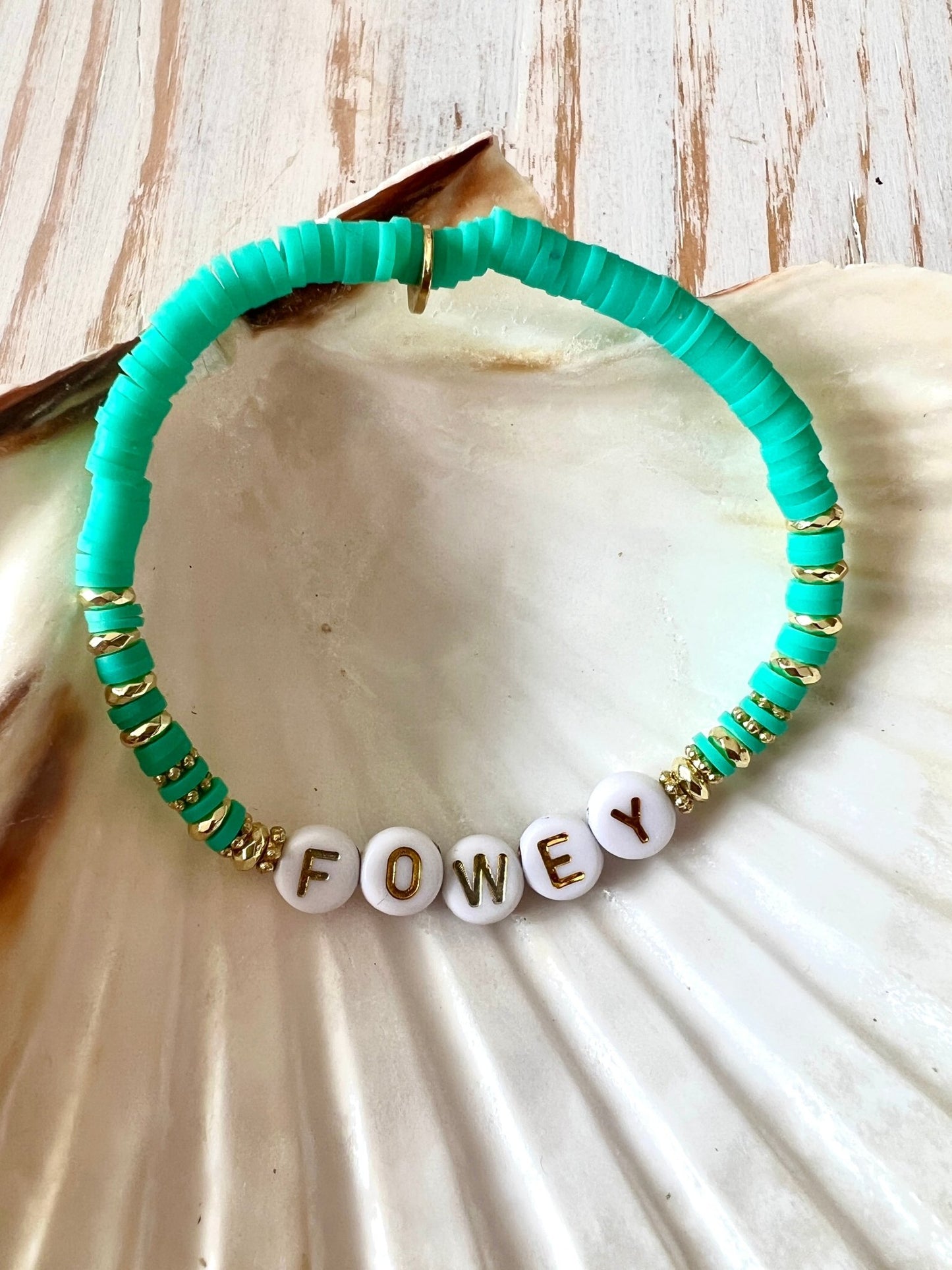 trendy sea turquoise beaded bracelet with FOWEY letter beads, gold accents, shell display, beach-inspired boho jewelry