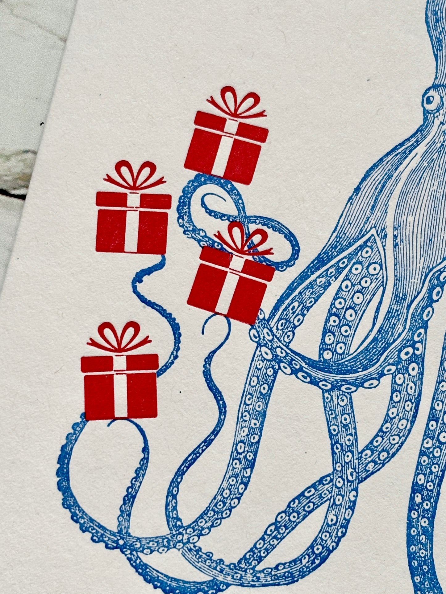 closeup shot of blue octopus card with red gifts, playful marine-themed design for whimsical birthday gifting and ocean lovers