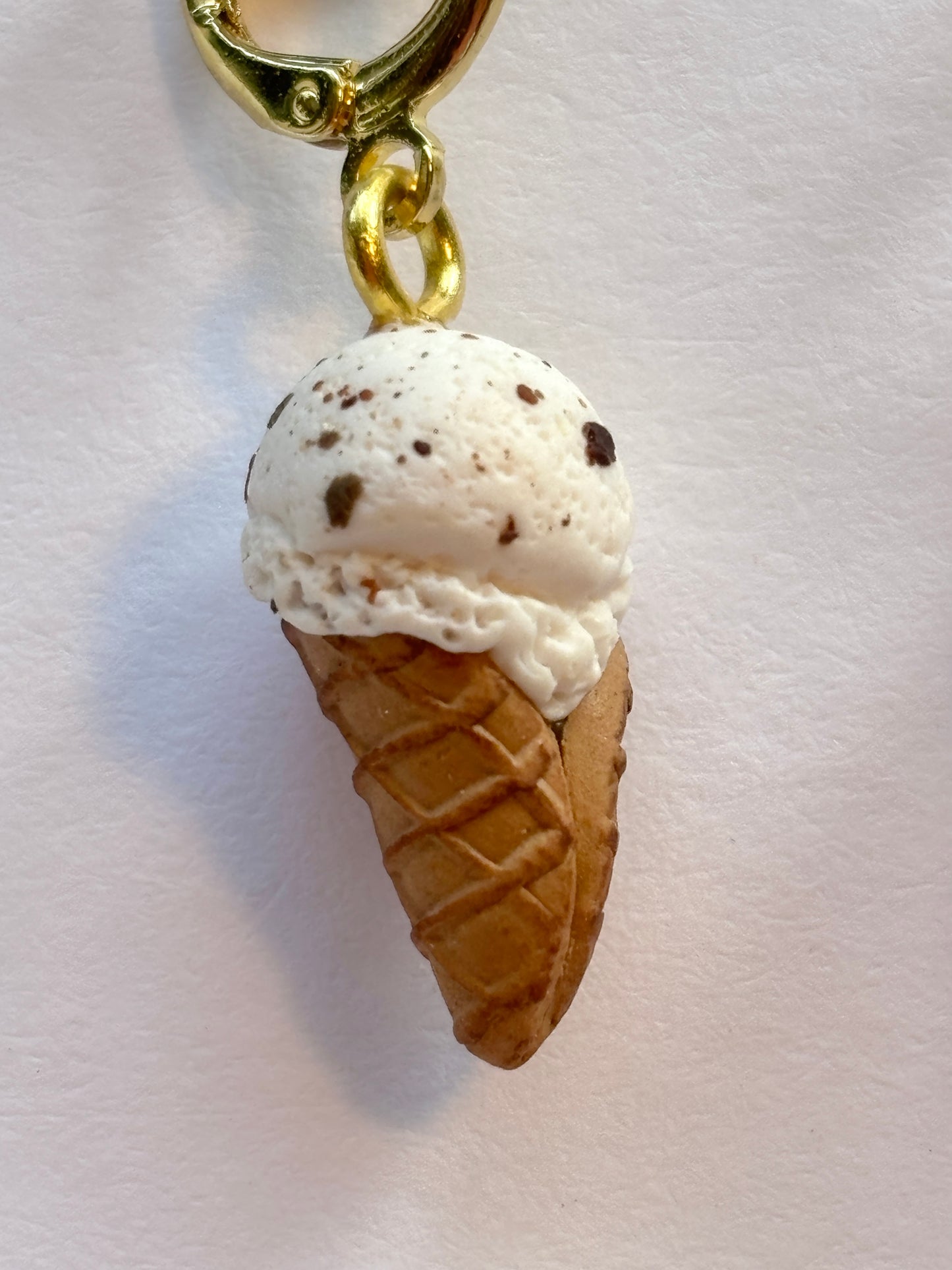 closeup shot of chocolate chip ice cream cone earring detailed miniature polymer clay jewelry unique summer food dangle