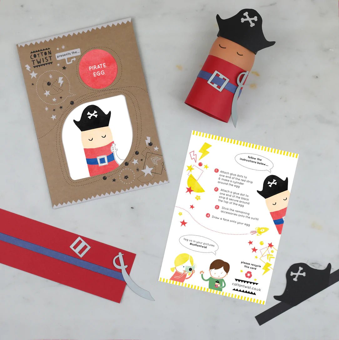 contents of the cotton twist pirate egg kit instruction card, brown envelope, pre-cut pieces (hat, belt, sword), and a finished DIY pirate egg