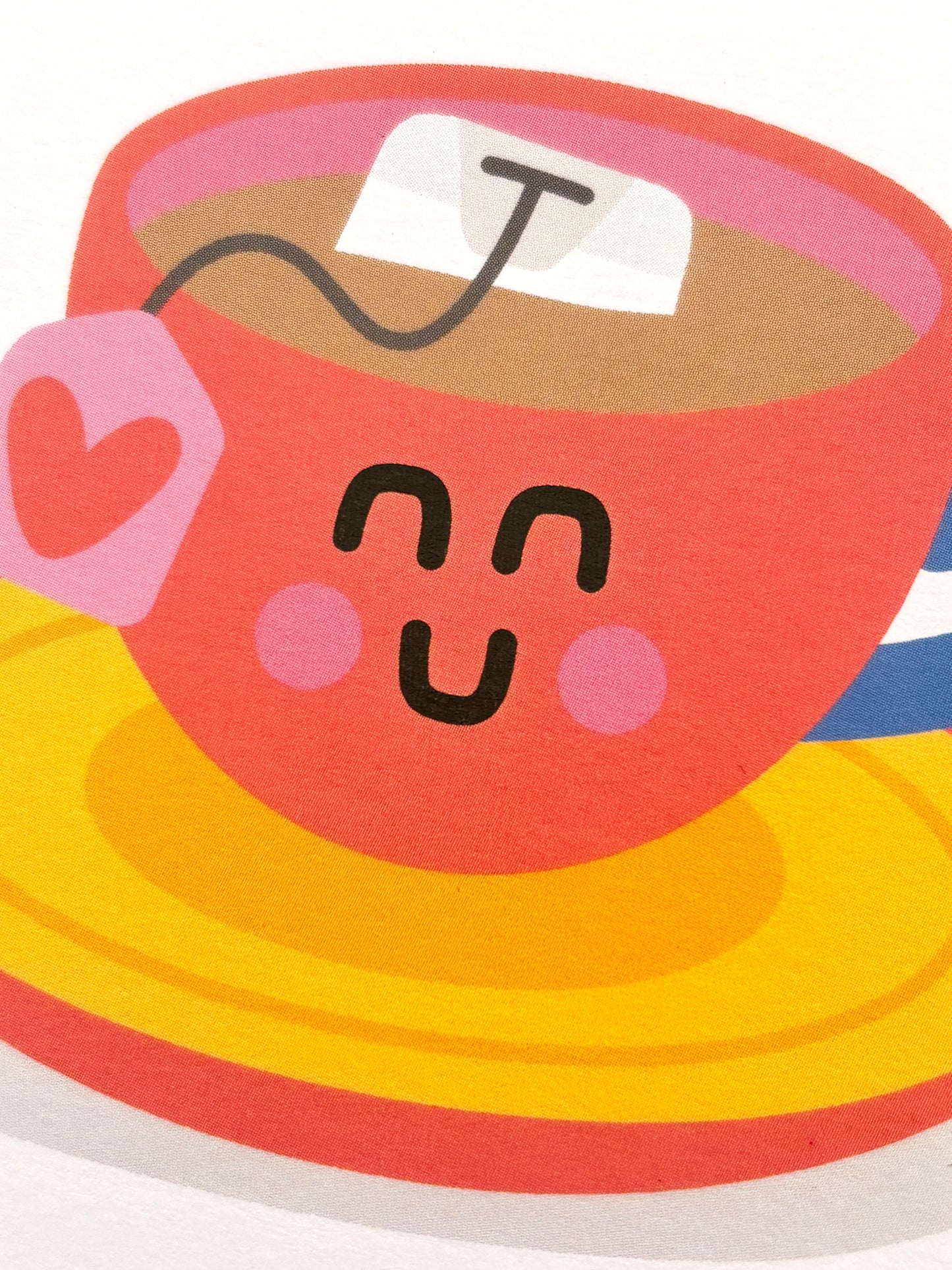 closeup shot of cute Mother's Day card with smiling teacup, heart tag, and pun “Best-Tea”—playful, tea-themed stationery