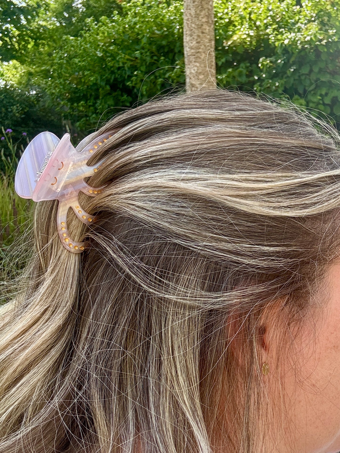 lifestyle photo of pink octopus hair claw worn in hair cute sea creature clip, glitter spots, coastal summer hair accessory