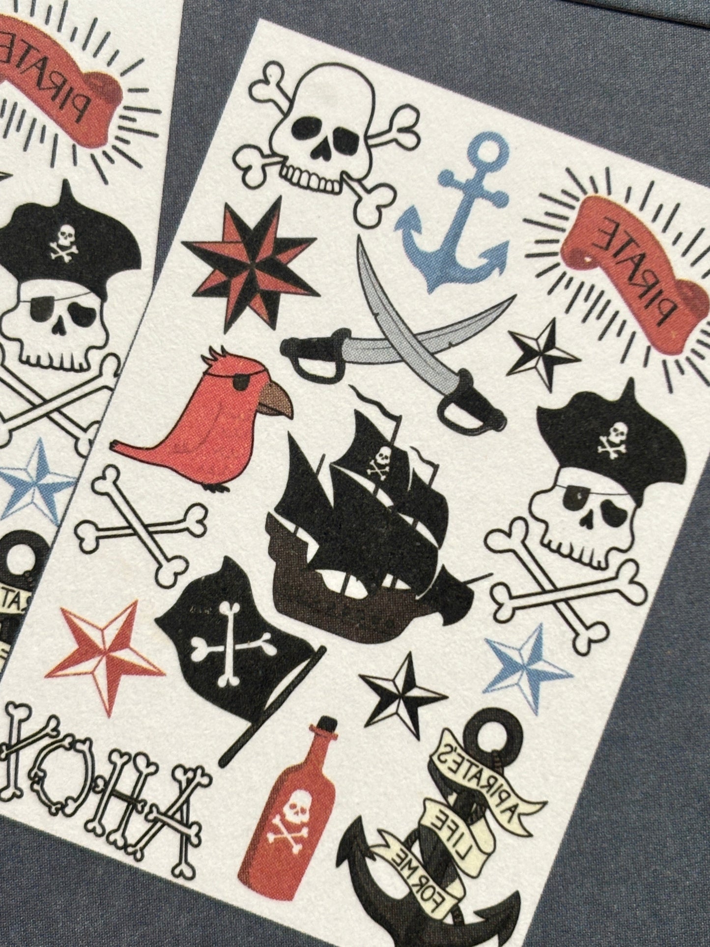 closeup shot of pirate temporary tattoos featuring skulls, ships, swords & slogans—ideal for party favors or costumes