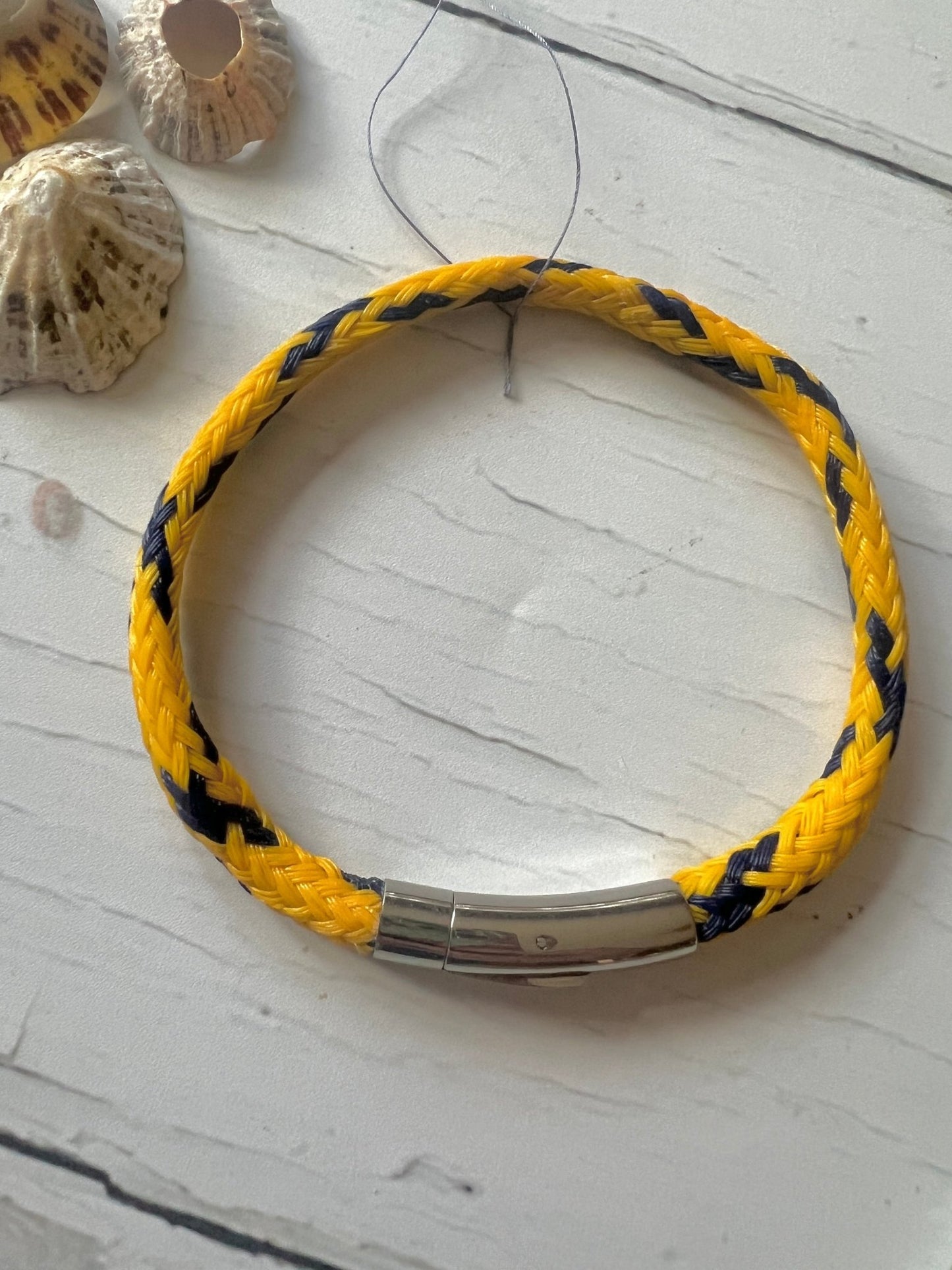 sustainable bracelet made from yellow recycled ghost fishing net braided, nautical cord, eco-friendly, stainless steel clasp
