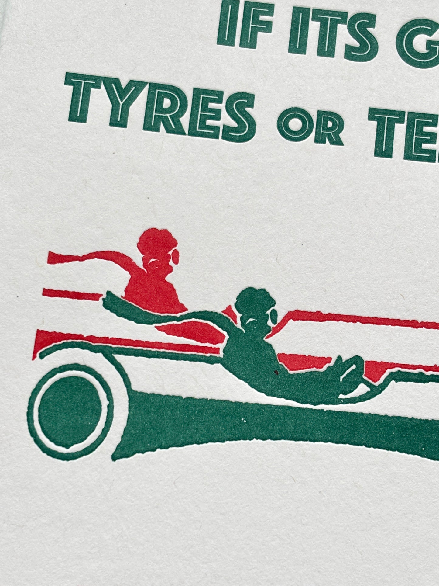 closeup shot of retro trouble card with bold green-red quote and race car, perfect for cheeky gifting and vintage humor lovers