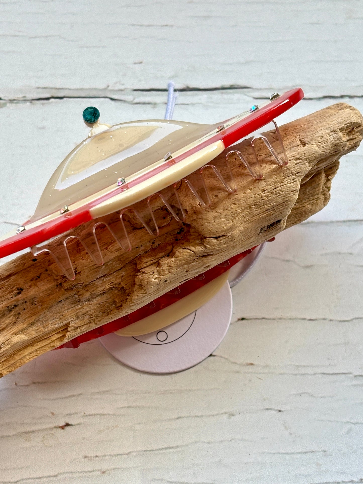 closeup shot of UFO spaceship hair claw—glossy, rhinestone-studded clip with cosmic charm and secure sci-fi-inspired grip