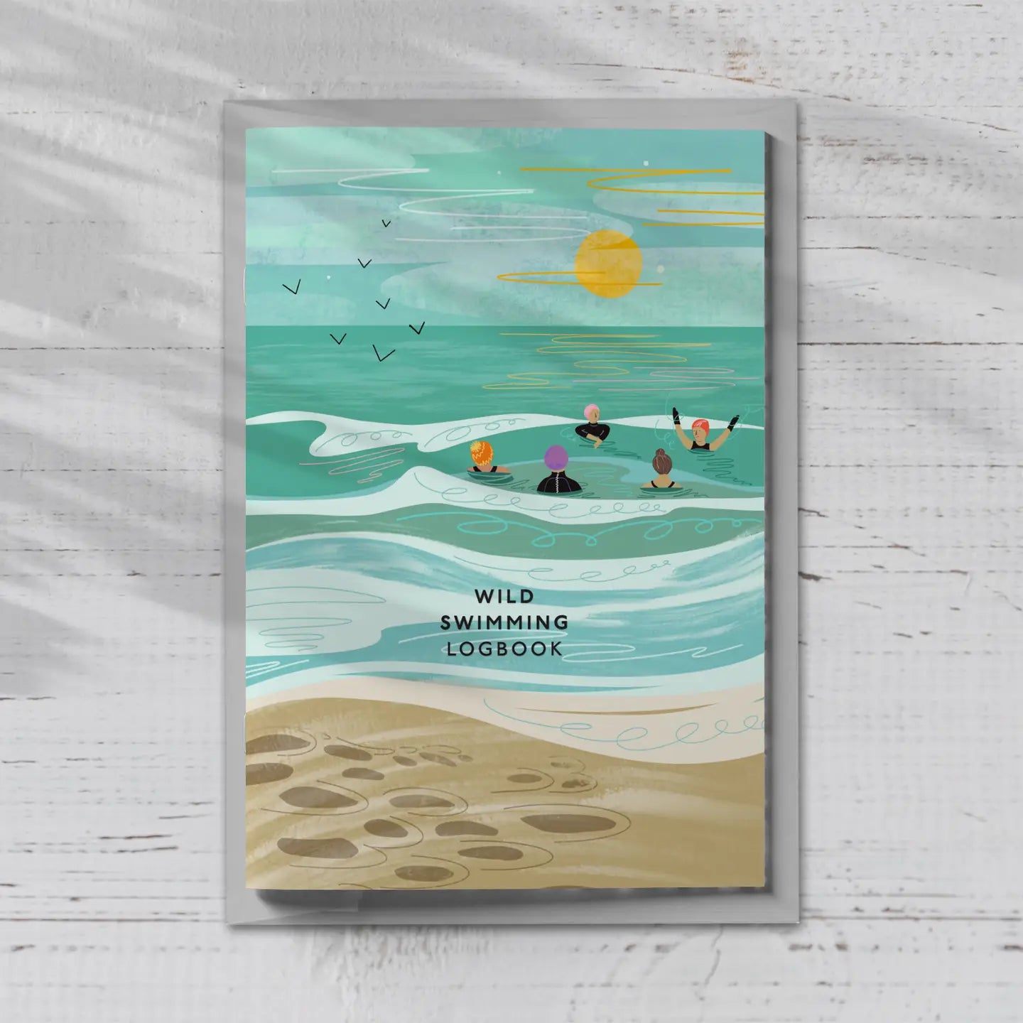 wild swimming logbook with beach scene cover—track ocean swims in this coastal-themed swim diary journal