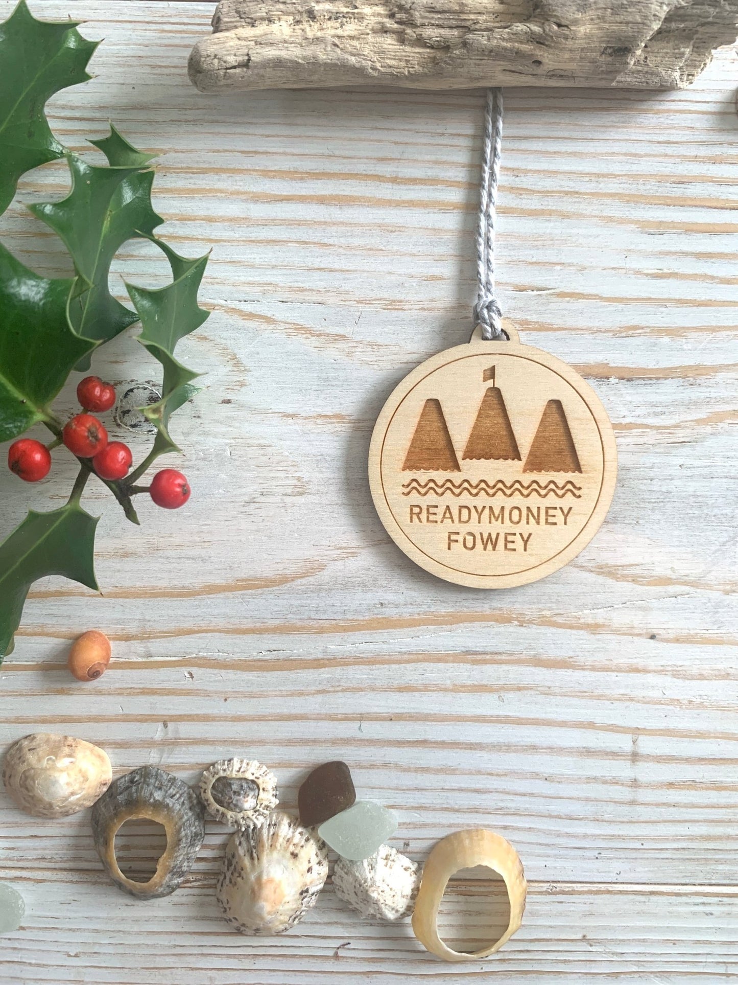 engraved round wooden Readymoney Fowey ornament, coastal holiday decor with mountain and sea motif