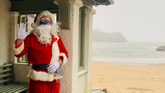 Santa by the Sea at Readymoney Cove, Fowey, Cornwall. Christmas 2020