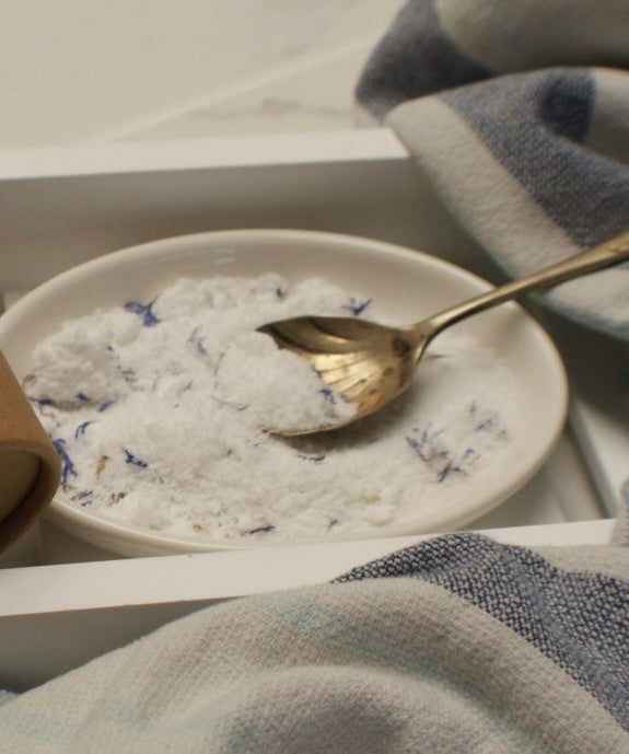 a plate of aromatherapy bath bomb dust with dried cornflowers 