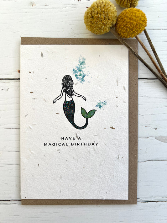 A natural coloured card embedded with meadow seeds featuring a mermaid design