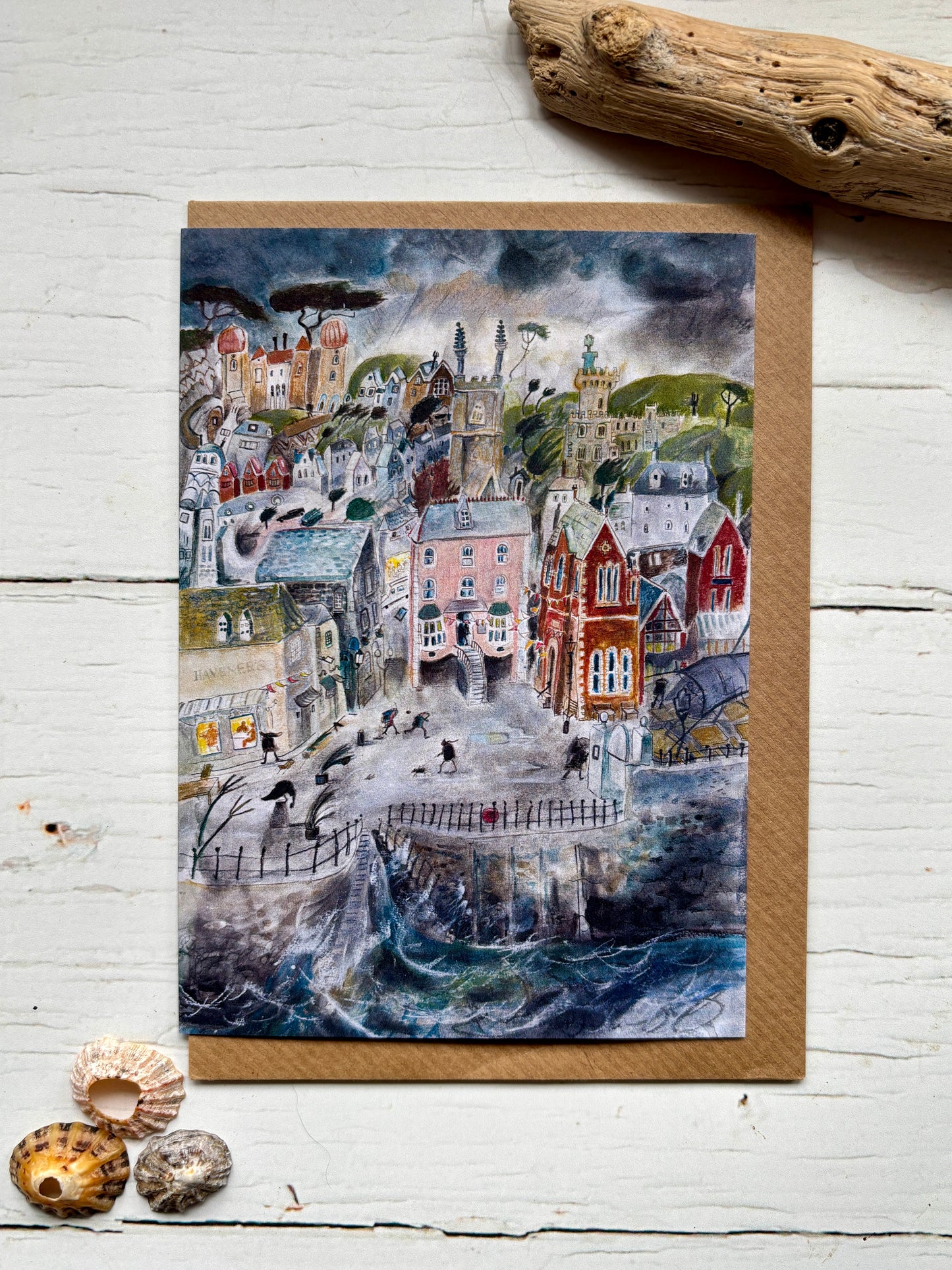 greeting card—stormy coastal town with pastel buildings, swirling waves, and moody sky for ocean lovers and art fans