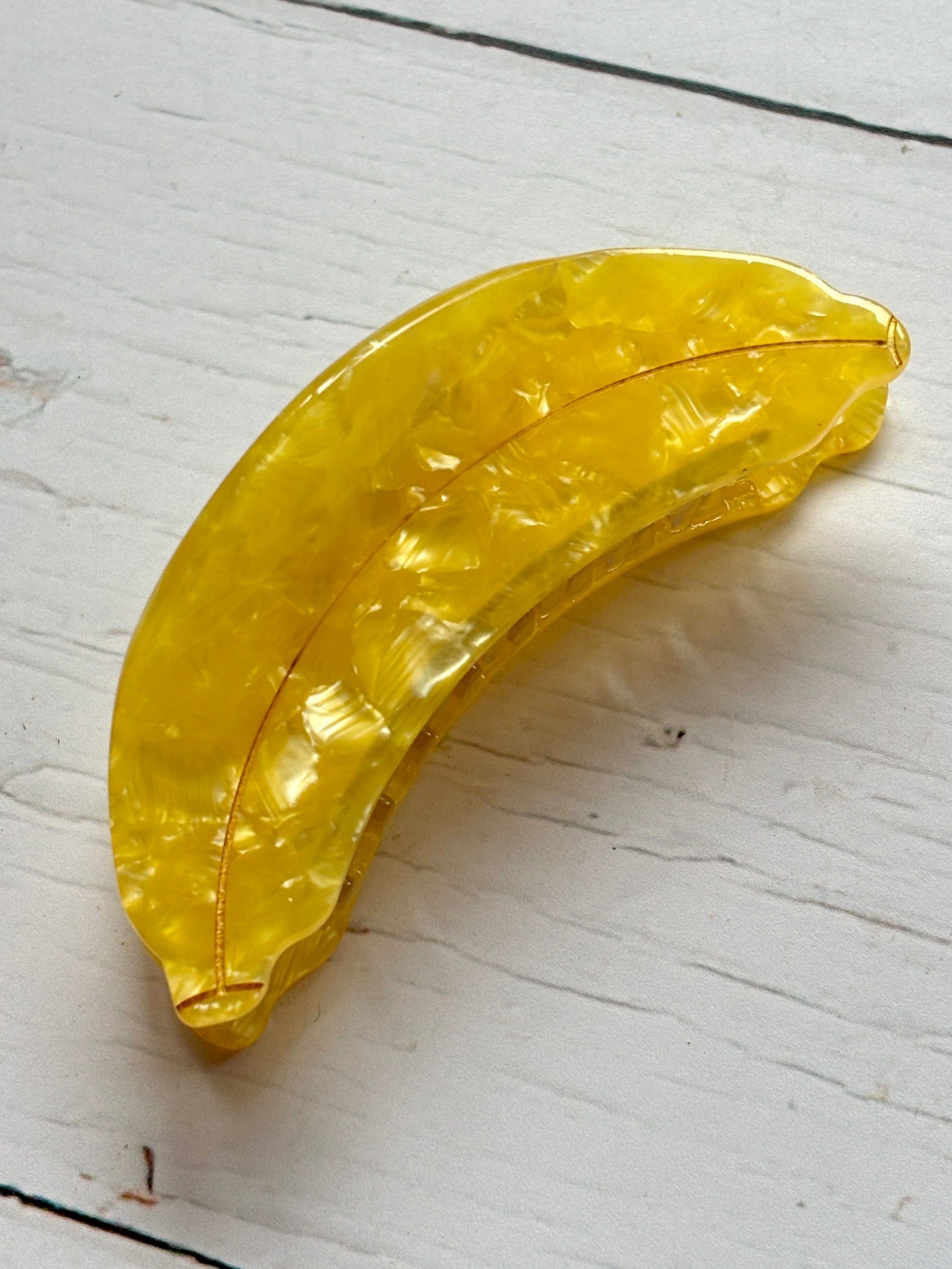banana-shaped hair claw clip in bright yellow marbled acrylic novelty fruit hair accessory, quirky gift idea