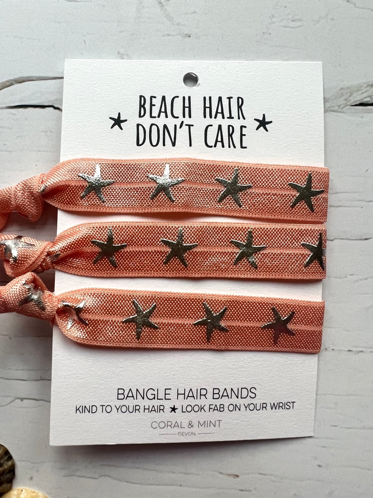 peach starfish print hair ties—beachy bangle bands that are gentle on hair and stylish on your wrist