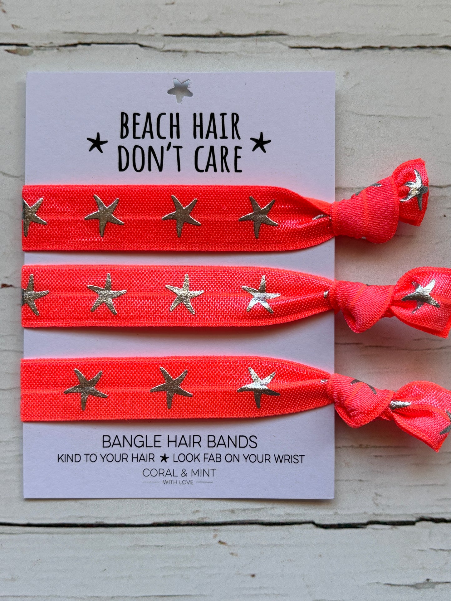 neon coral star hair ties—beachy bangle bands that add vibrant coastal style to hair and wrist
