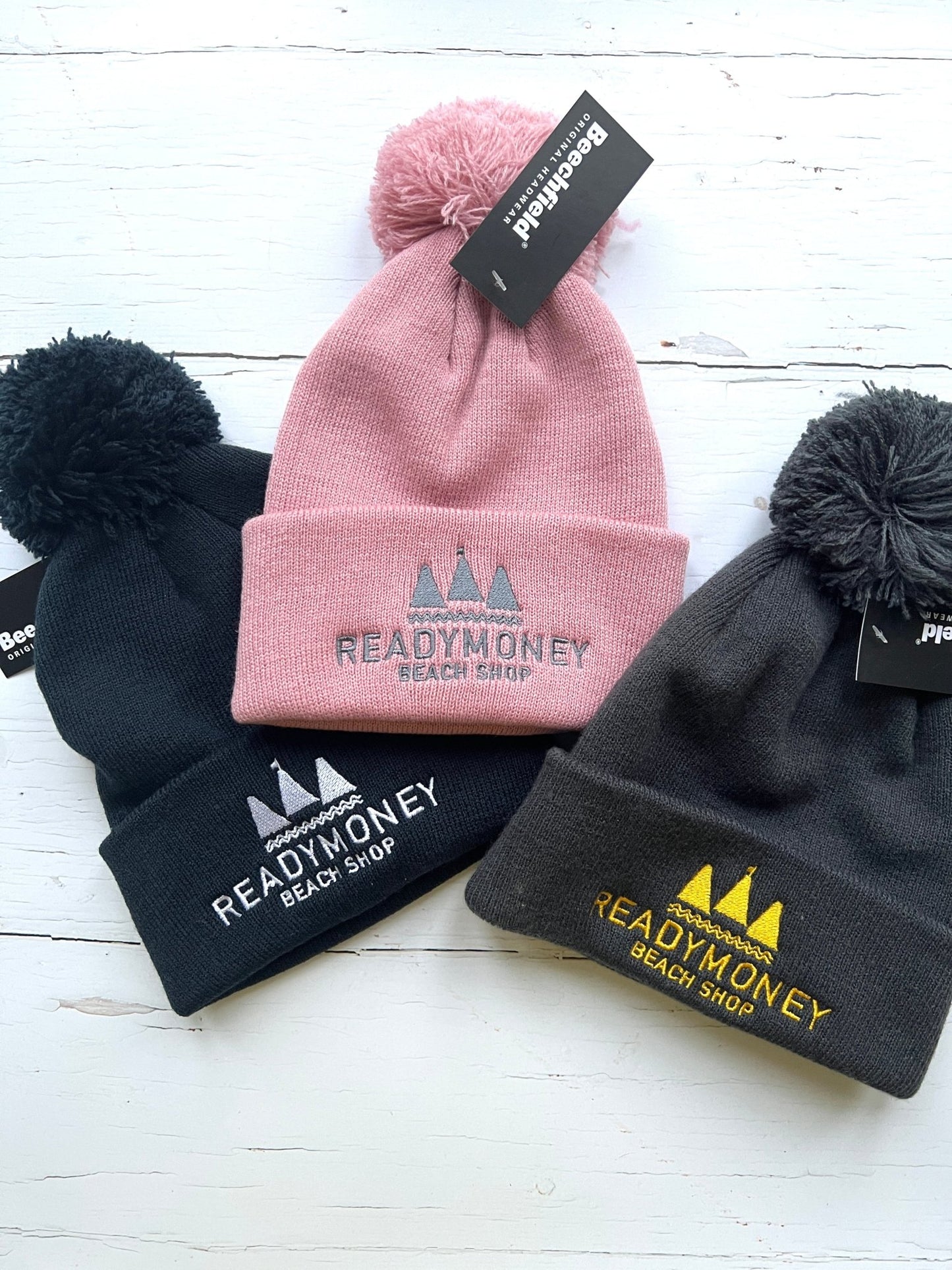 cozy kids’ beanie with pom-pom, embroidered beach shop logo, and soft knit for chilly coastal days