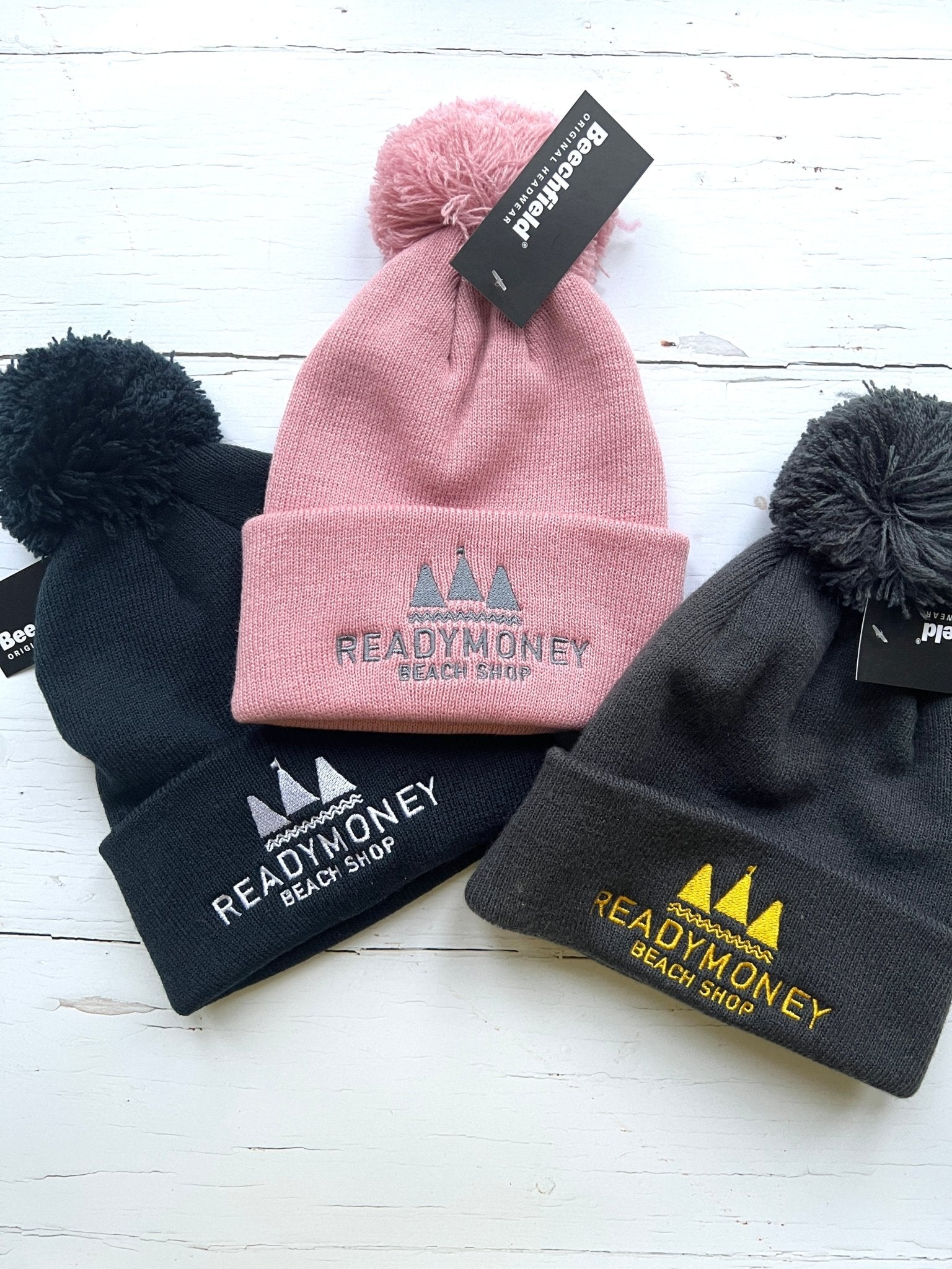 cozy kids’ beanie with pom-pom, embroidered beach shop logo, and soft knit for chilly coastal days