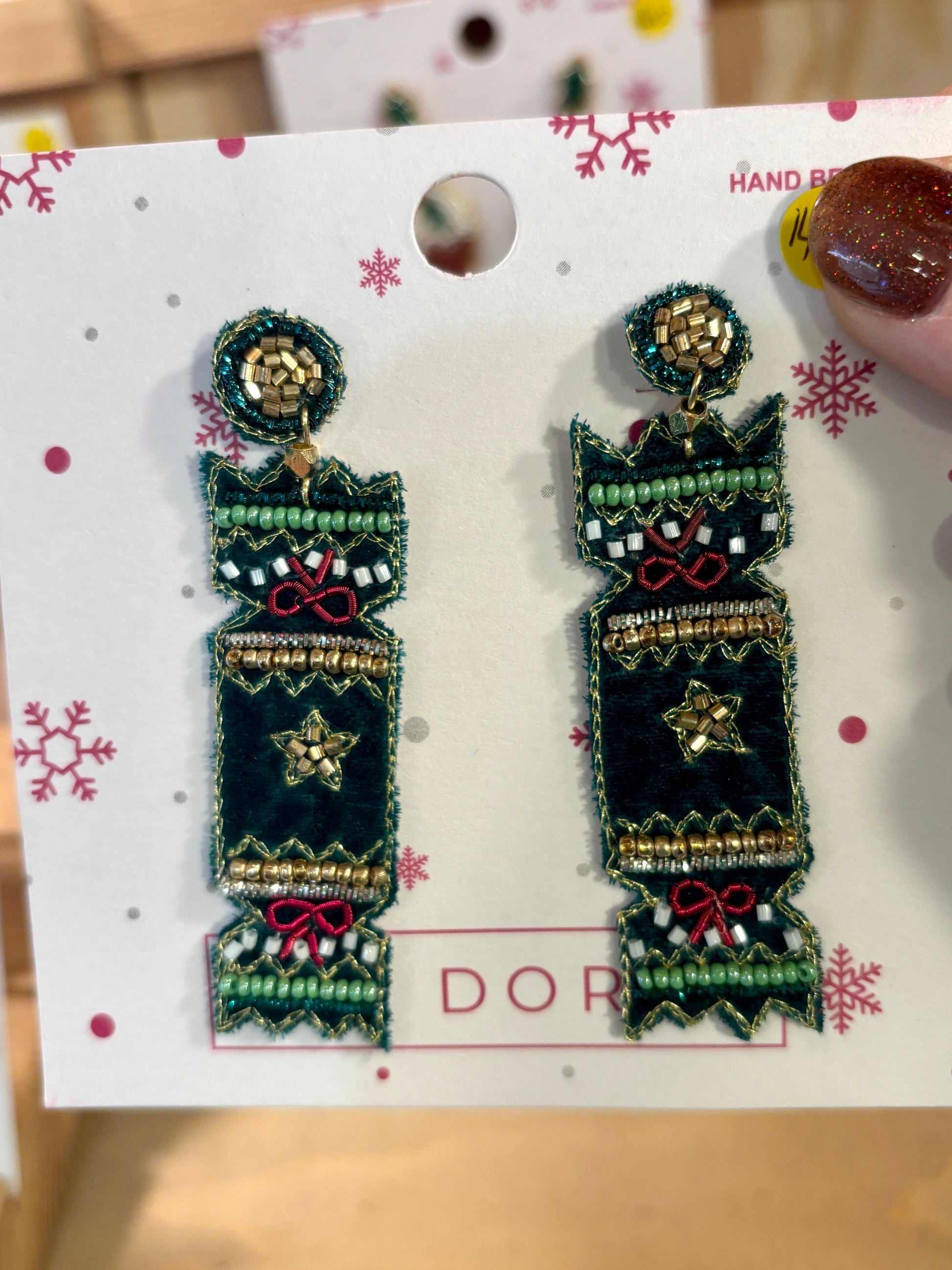 a pair of green velvet beaded cracket shaped earrings