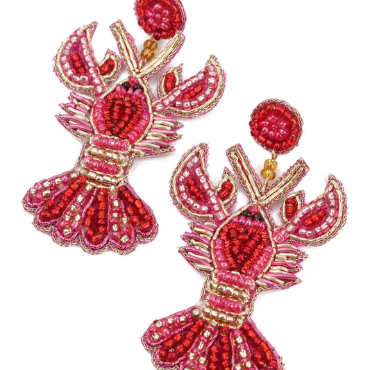Pair of red and gold lobster-shaped earrings on a white background