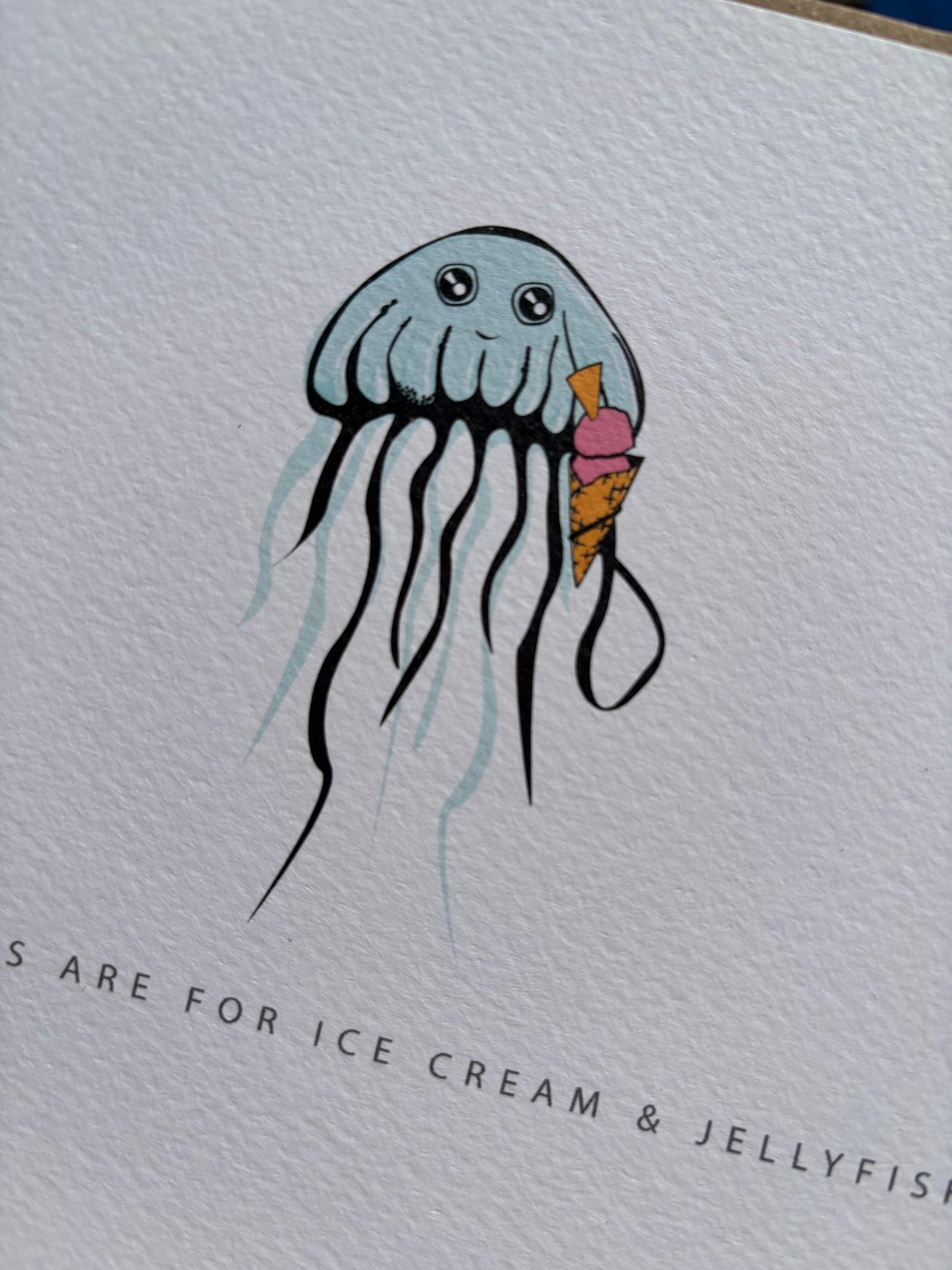 closeup shot of birthday ice cream jellyfish card—cheerful jellyfish with cone on textured cardstock, ideal for ocean-themed birthday celebrations