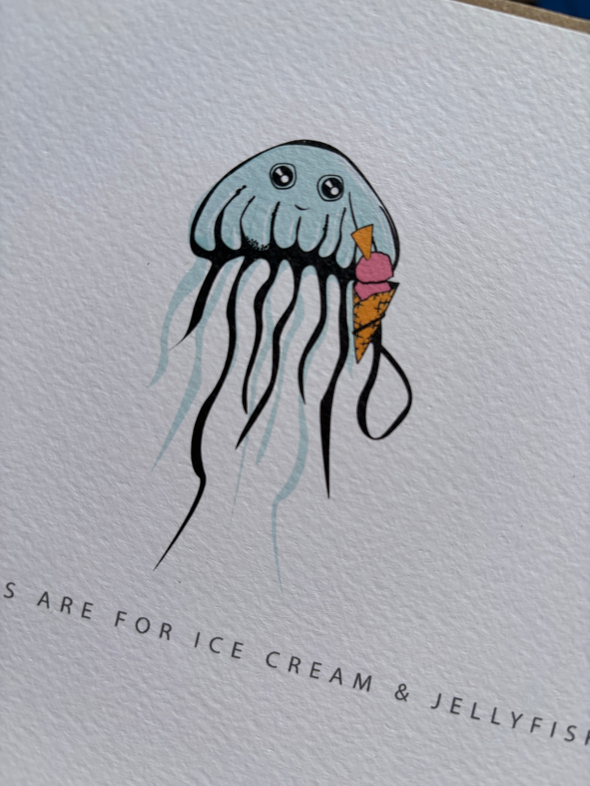 closeup shot of birthday ice cream jellyfish card—cheerful jellyfish with cone on textured cardstock, ideal for ocean-themed birthday celebrations