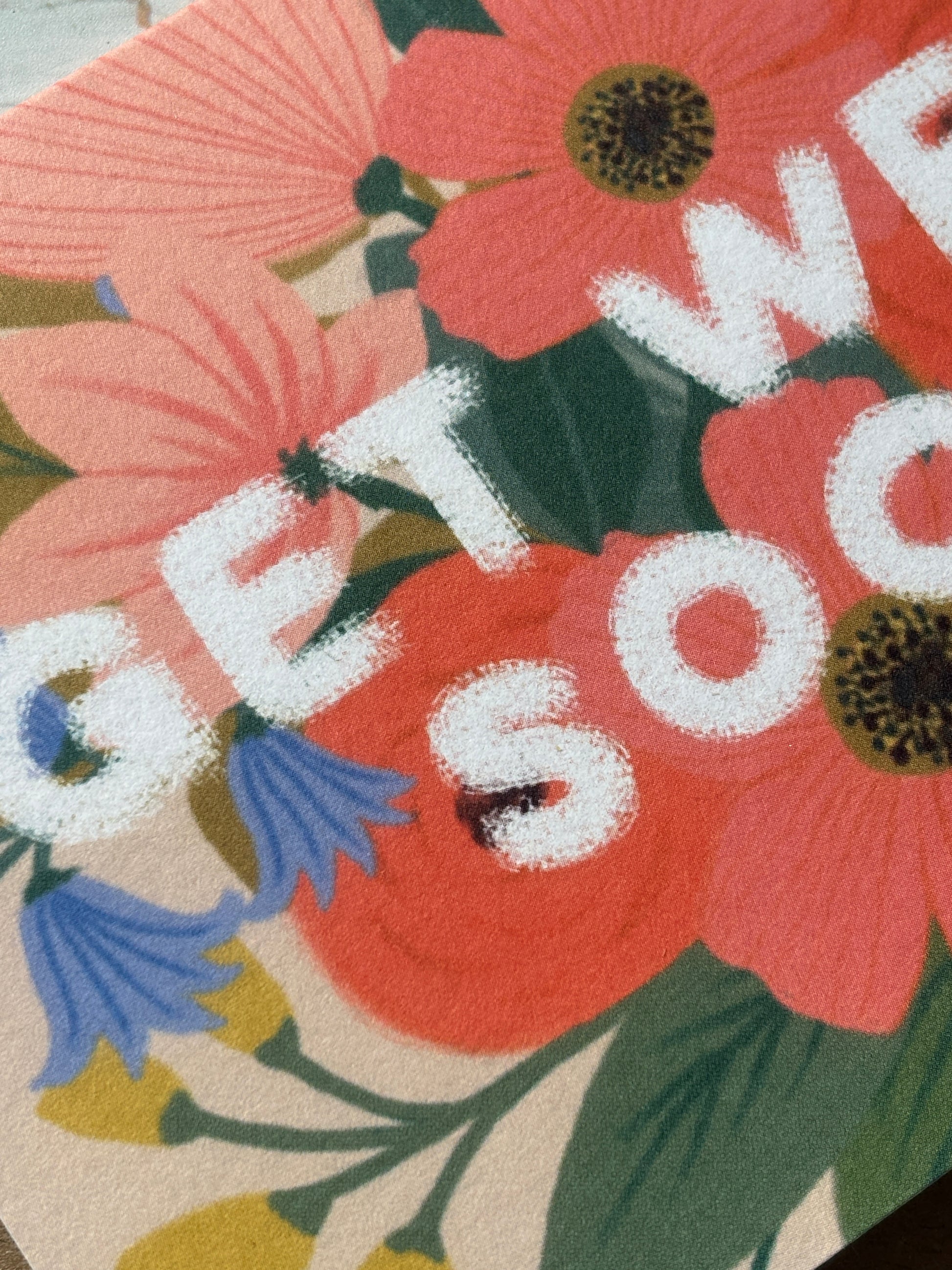closeup shot of floral get well card—vibrant blooms and bold white text offer cheerful, uplifting recovery vibes