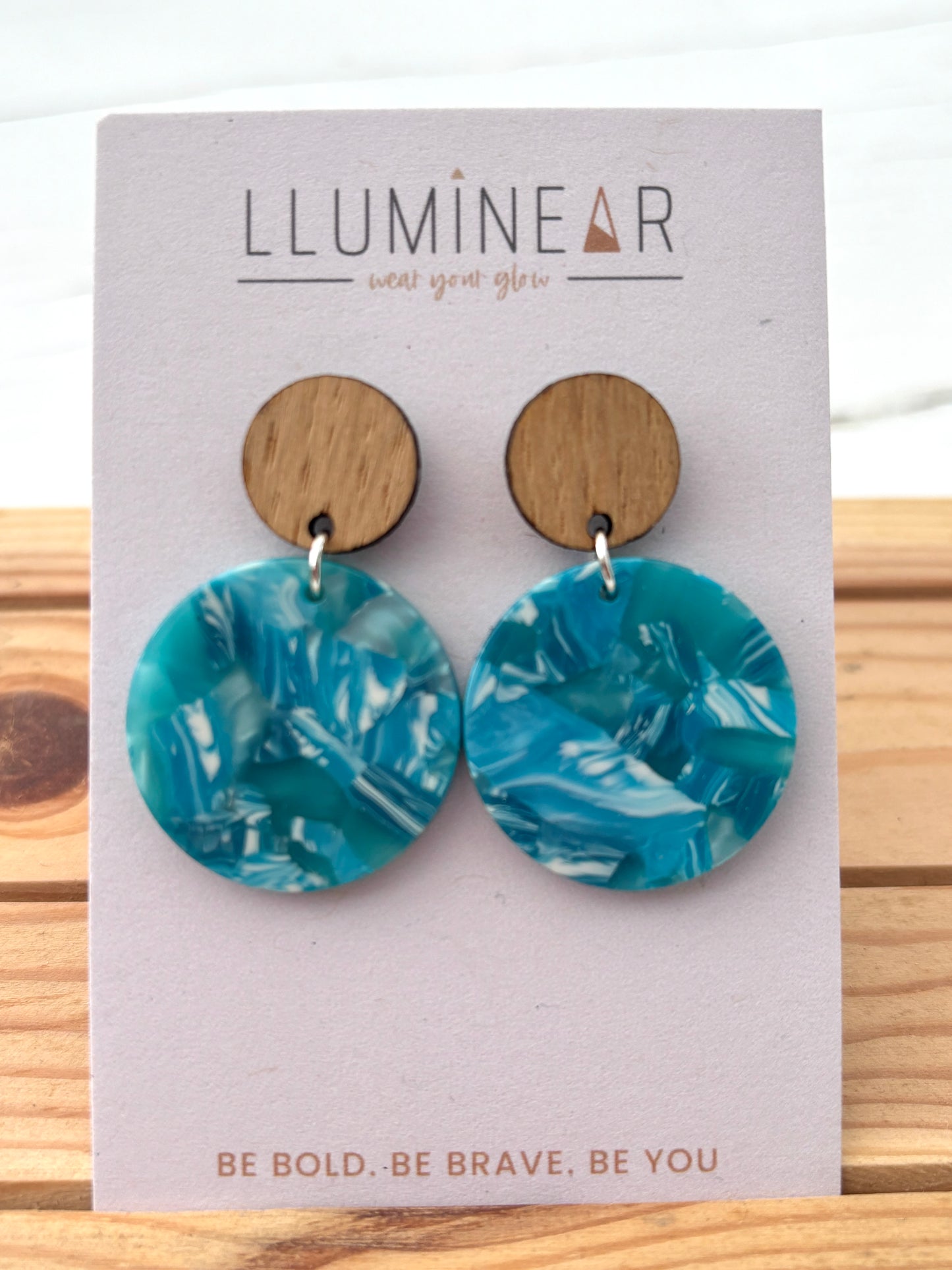 blue swirly hoop earrings with wood studs and marbled resin; bold handcrafted statement jewelry for everyday wear