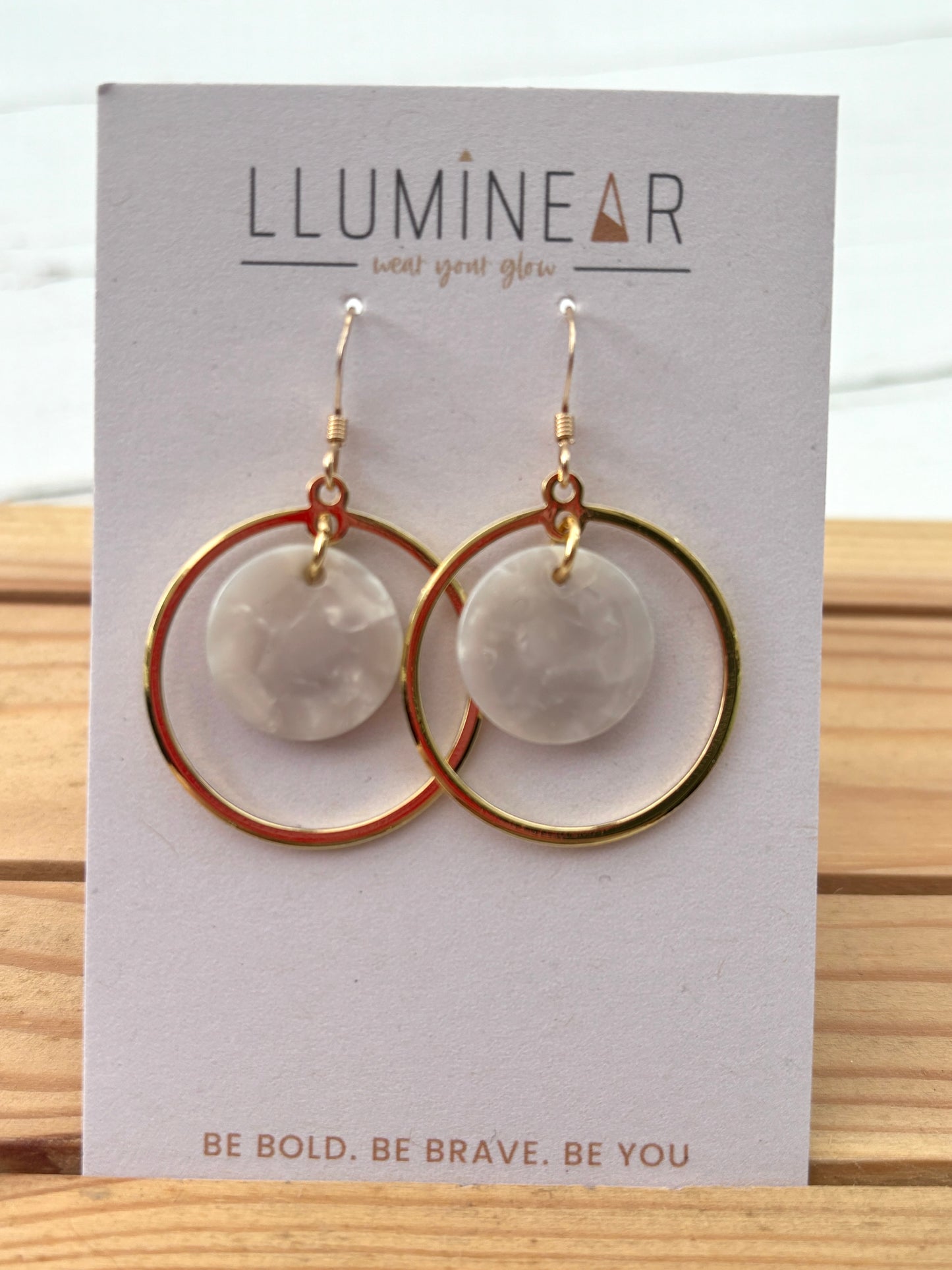 gold hoop earrings with marbled white resin discs—lightweight, bold, everyday statement jewelry for modern style