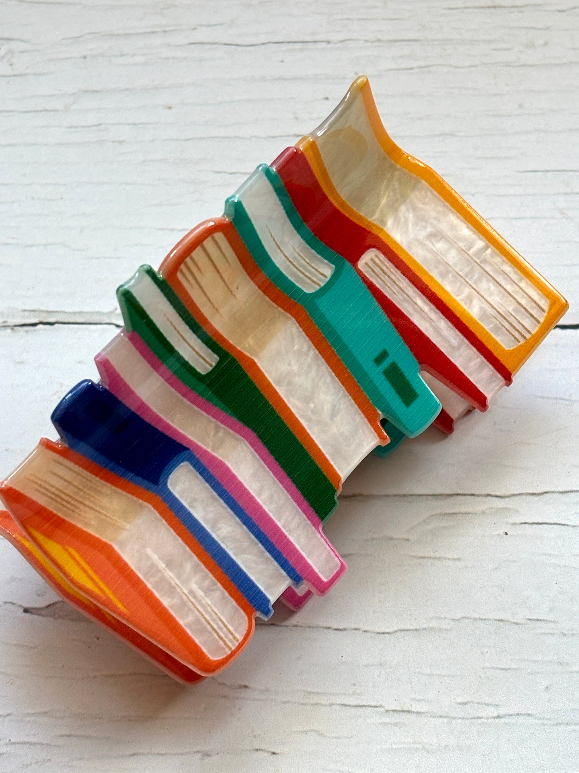funky colorful hair claw clip shaped like a stack of books with marbled acrylic covers novelty hair accessory for readers and librarians.
