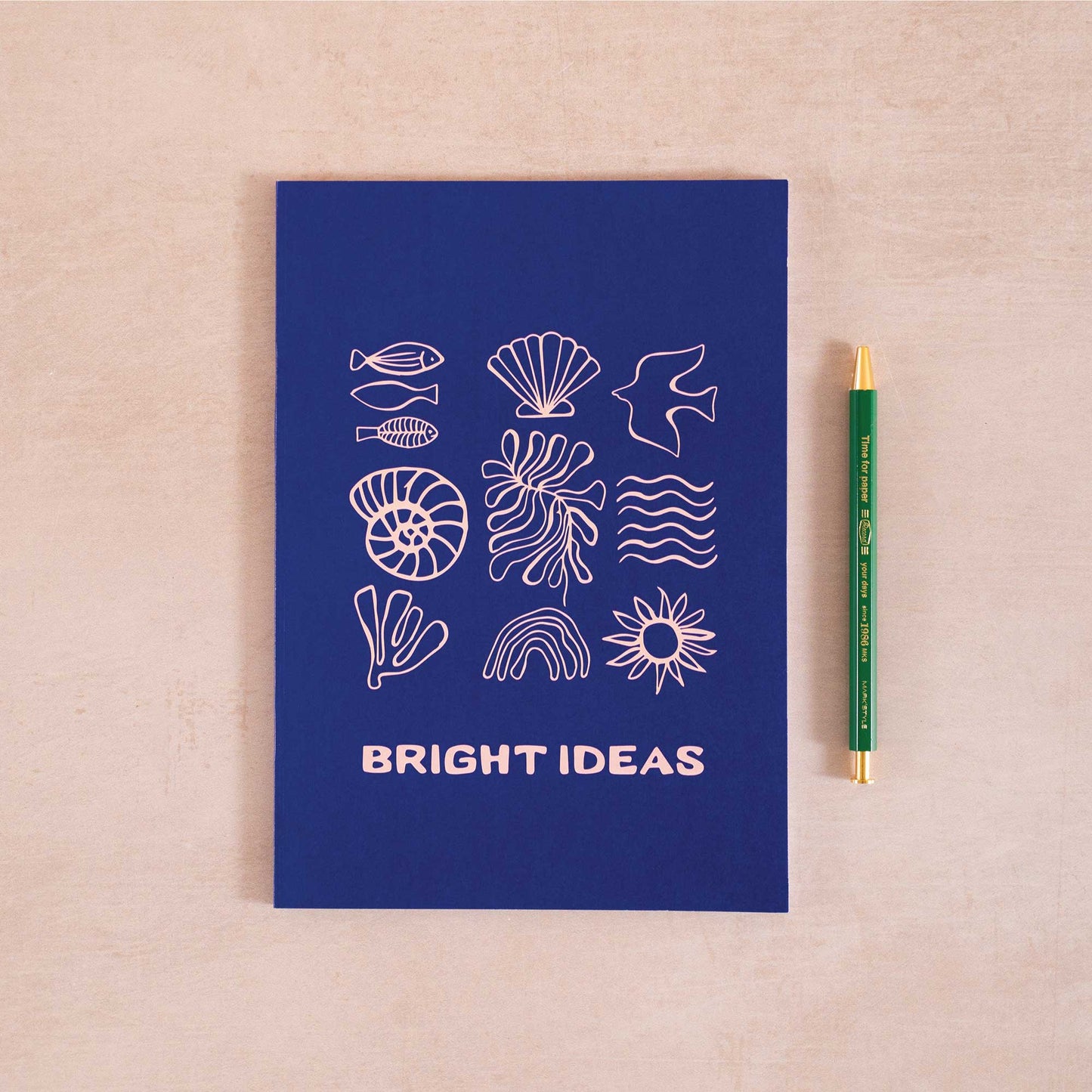 “Bright Ideas” coastal notebook in navy with sea icon cover—styled with pen for eco-friendly journaling, gifting, and creativity