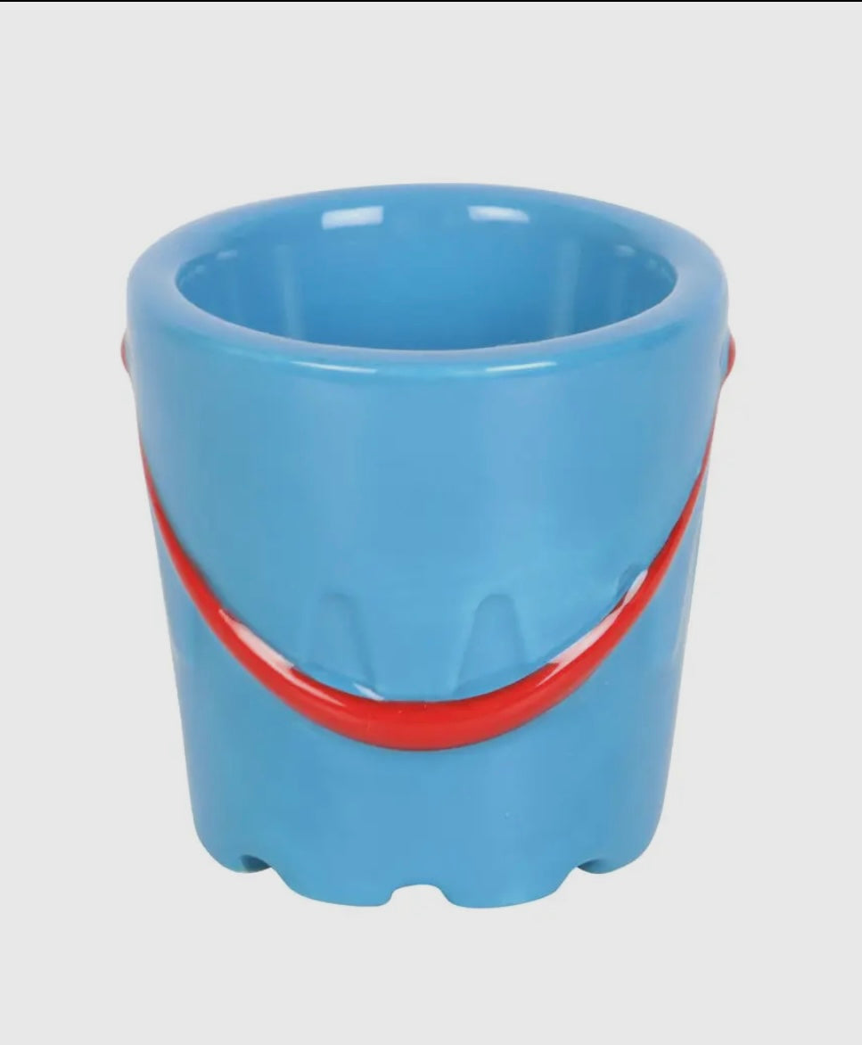 glossy blue ceramic bucket with red handle—playful beach-style egg cup perfect for coastal kitchen decor