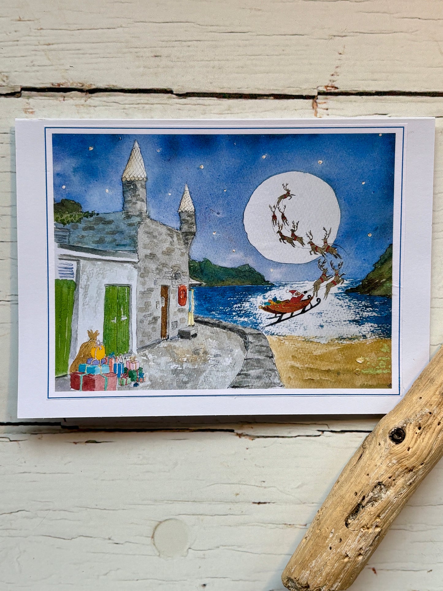 Christmas at Readymoney Cove watercolor card santa and sleigh over the sea by the castle Cornish Christmas cards, seaside holiday