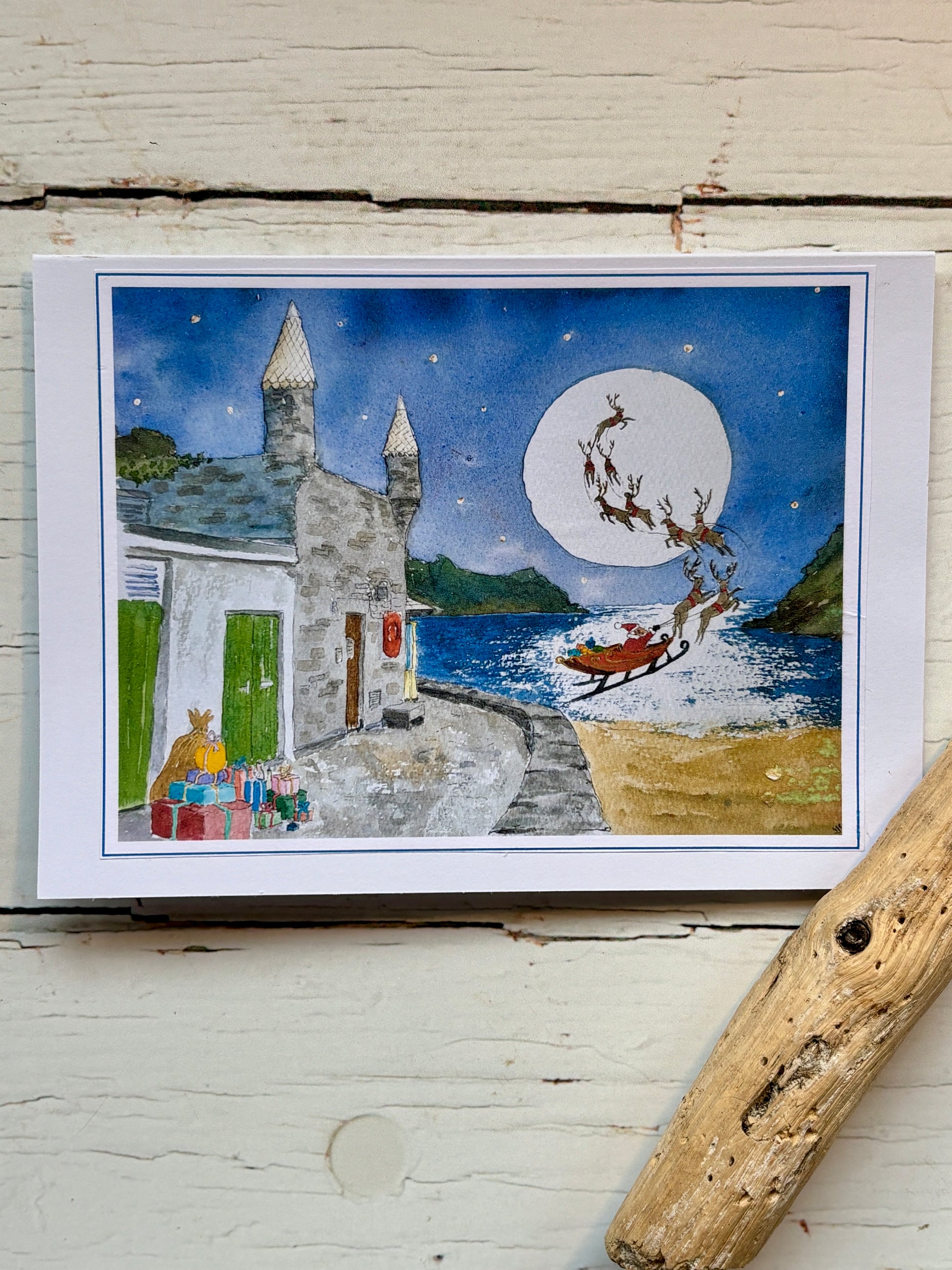 Christmas at Readymoney Cove watercolor card santa and sleigh over the sea by the castle Cornish Christmas cards, seaside holiday