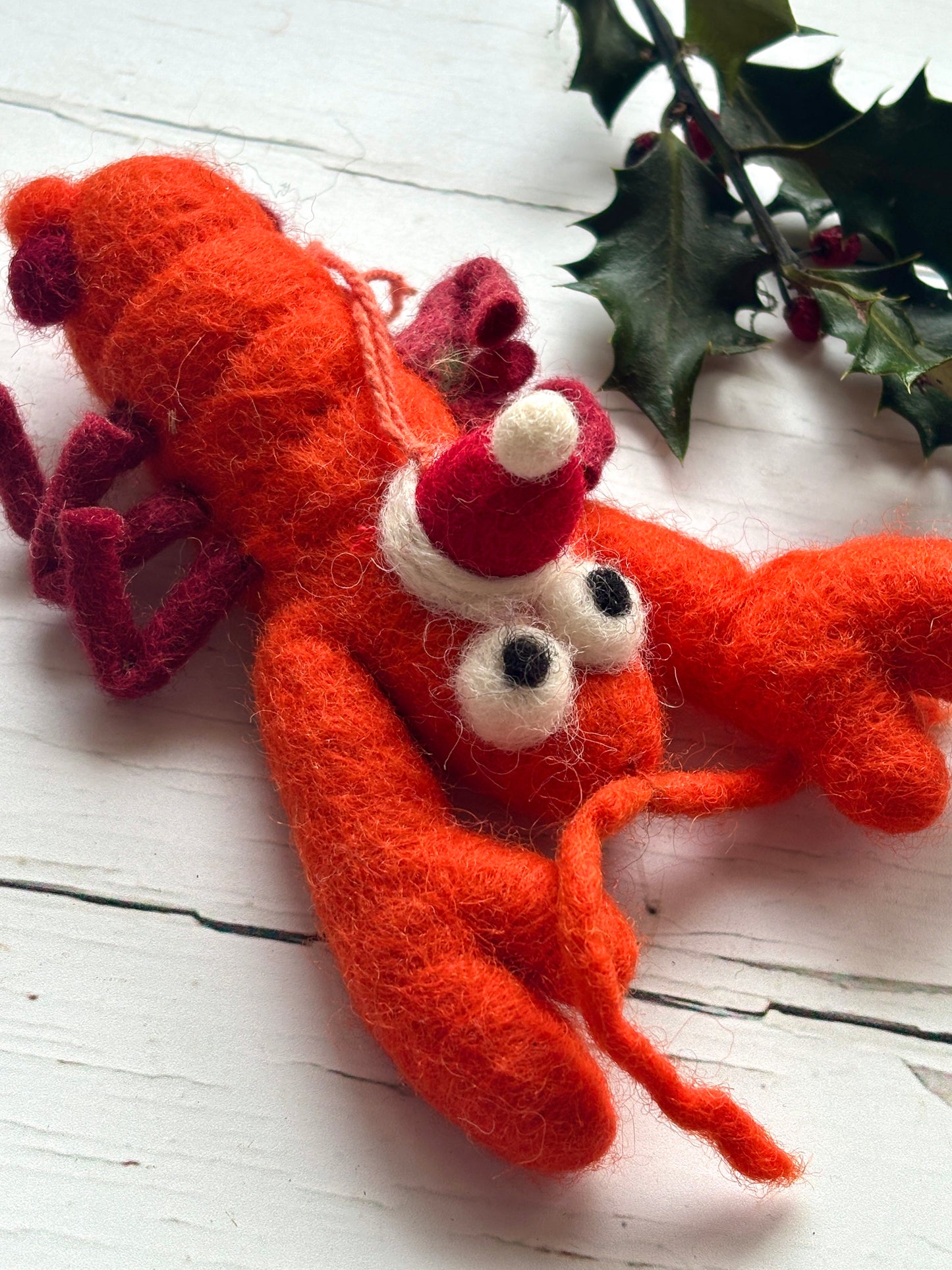 handmade felt lobster ornament. Orange crustacean with a Santa hat coastal Christmas tree decoration and seafood novelty gift