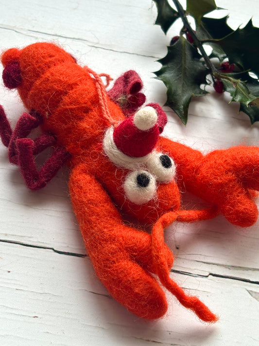 handmade felt lobster ornament. Orange crustacean with a Santa hat coastal Christmas tree decoration and seafood novelty gift