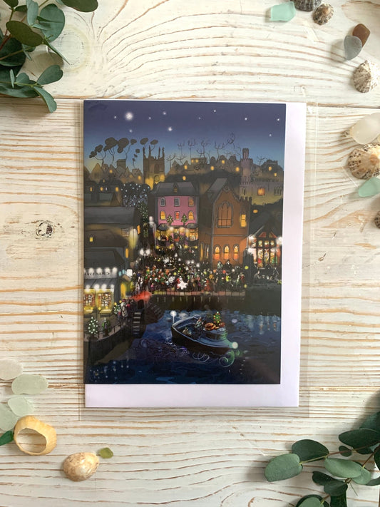 Christmas on Town Quay greeting card artwork of a festive seaside town with lights and a decorated boat Cornish holiday cards