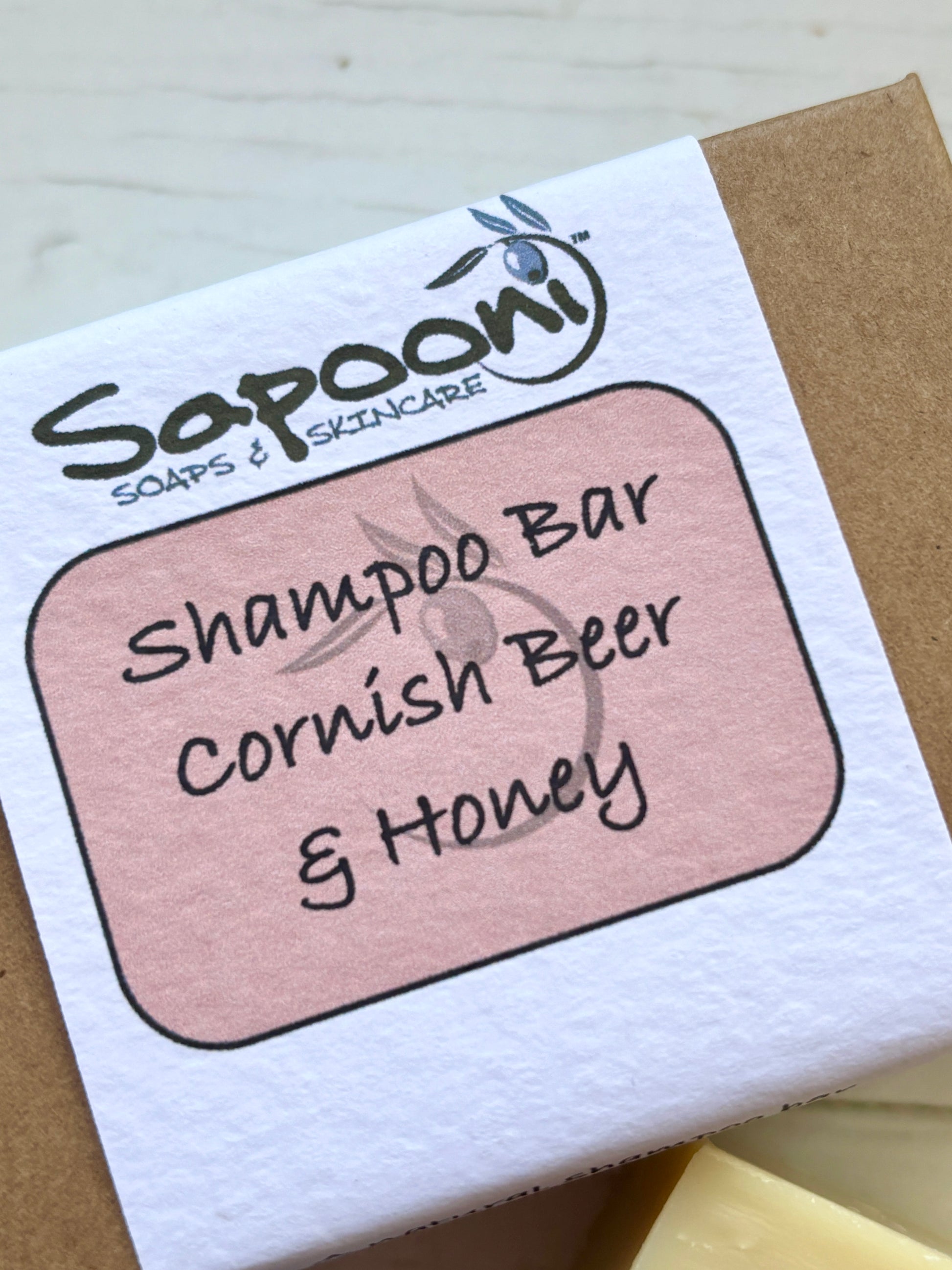 closeup shot of a Sapoori Soaps & Skincare Cornish Beer & Honey Shampoo Bar package natural, solid shampoo for healthy hair