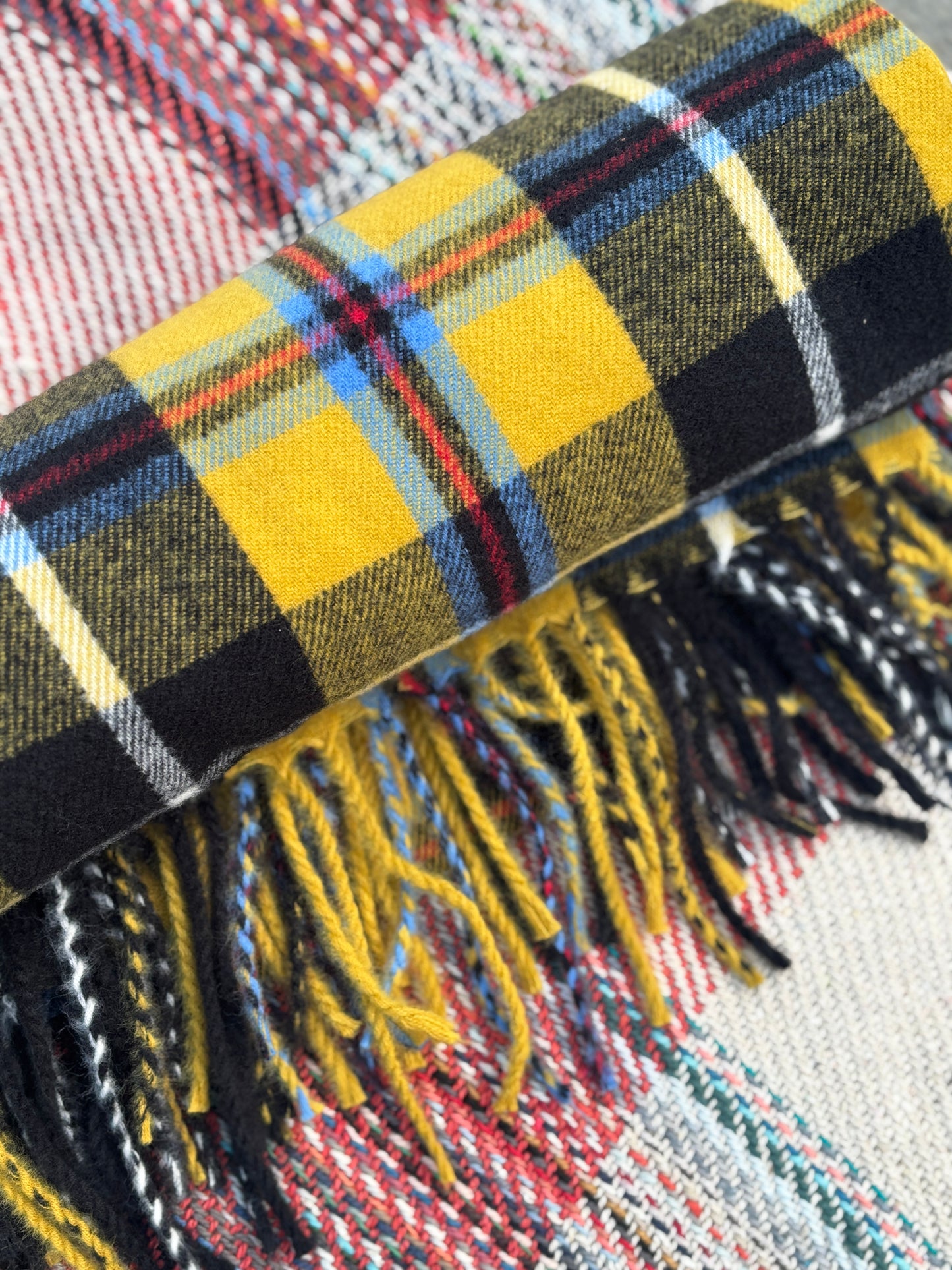 rolled yellow tartan blanket with fringe warm woolen throw for coastal picnics or winter comfort Cornish gift item