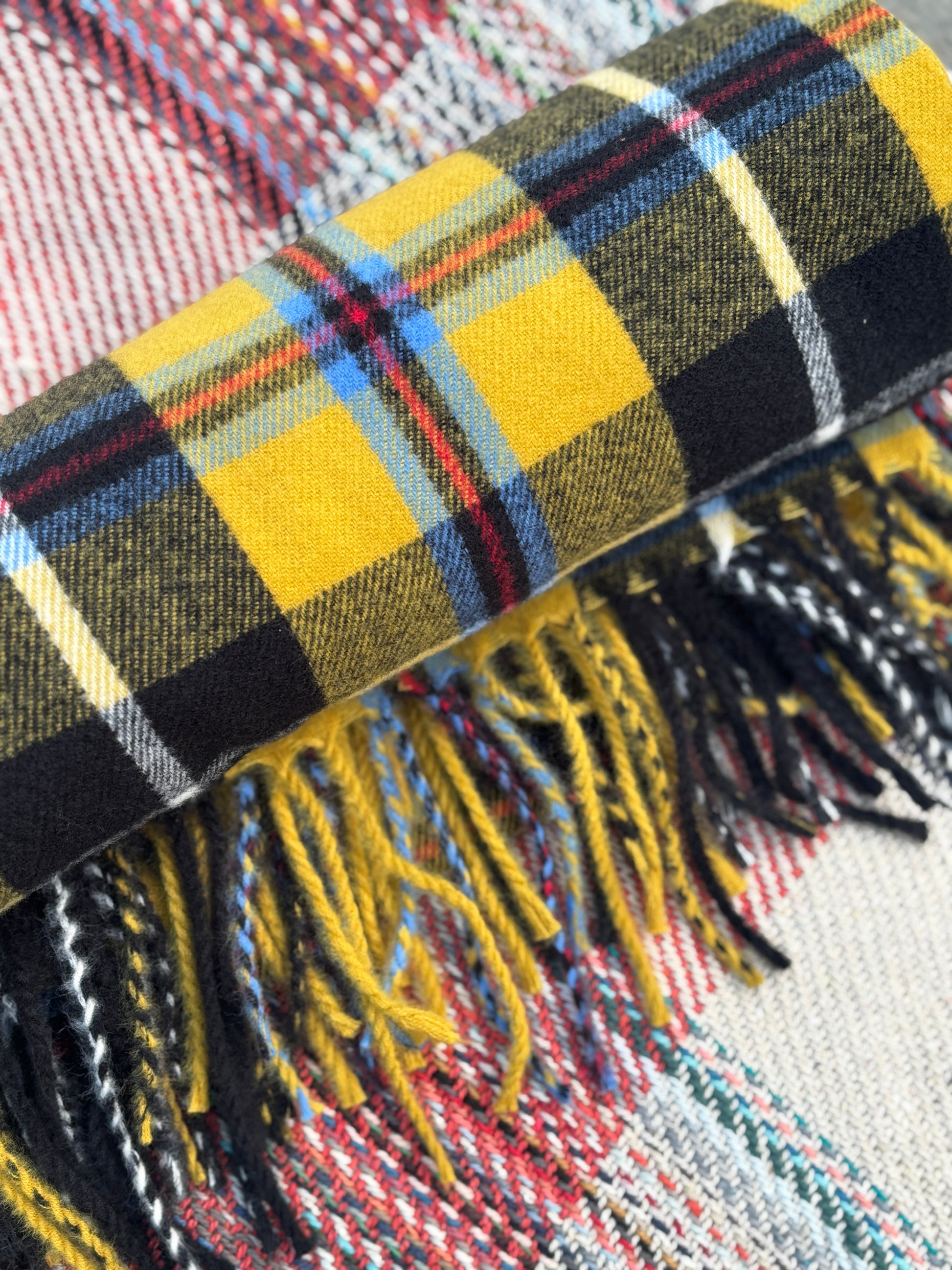 rolled yellow tartan blanket with fringe warm woolen throw for coastal picnics or winter comfort Cornish gift item