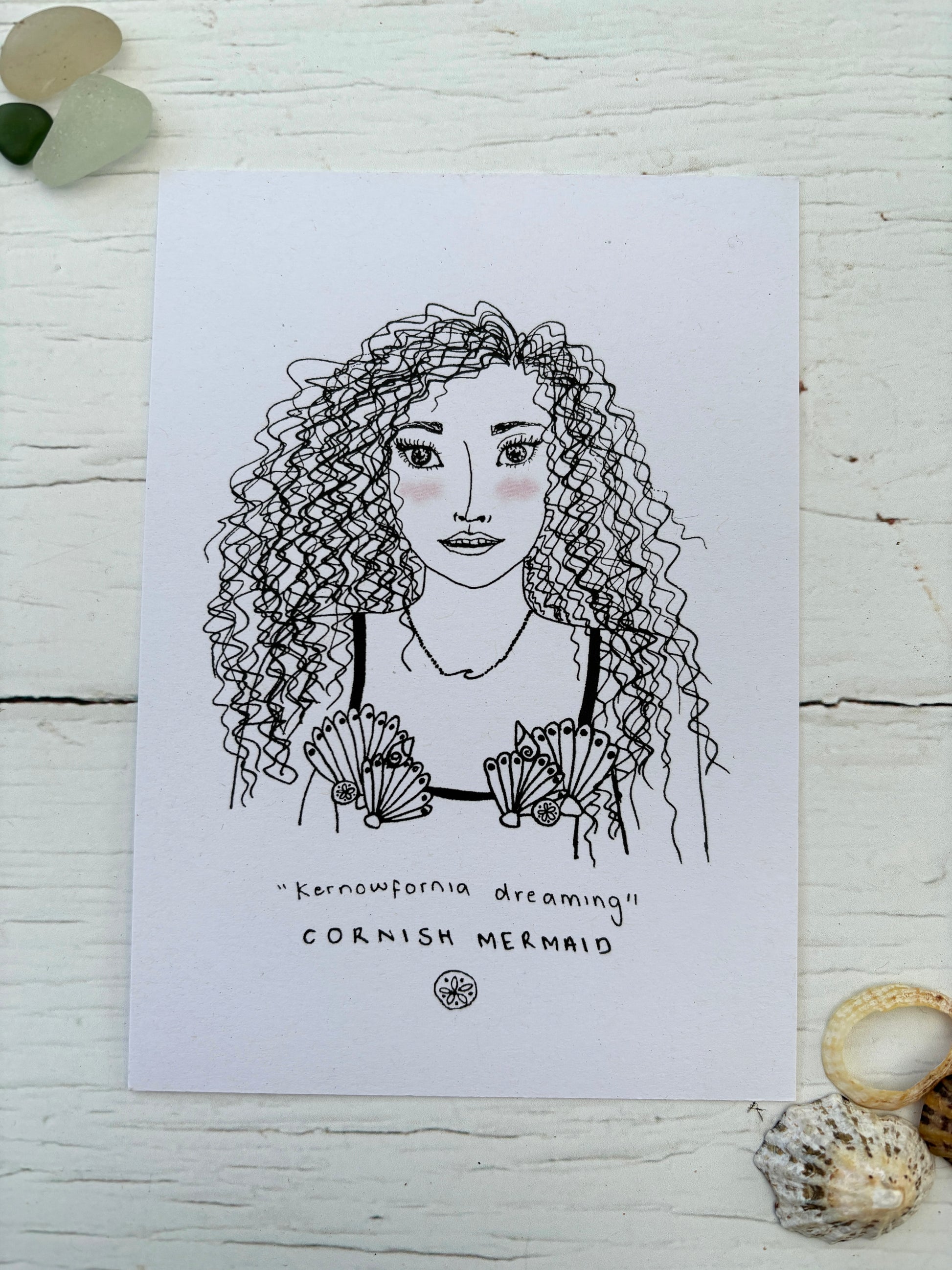 black and white Mermaid postcard Kernowfornia dreaming text with curly-haired coastal folk art woman wearing seashells