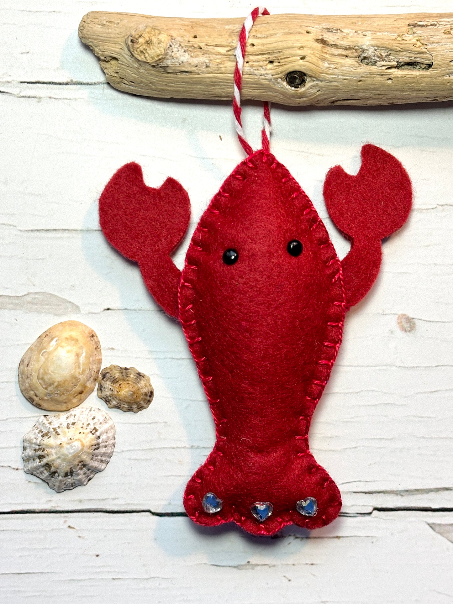 red felt lobster Christmas ornament on driftwood with glitter hearts and shells marine life decor