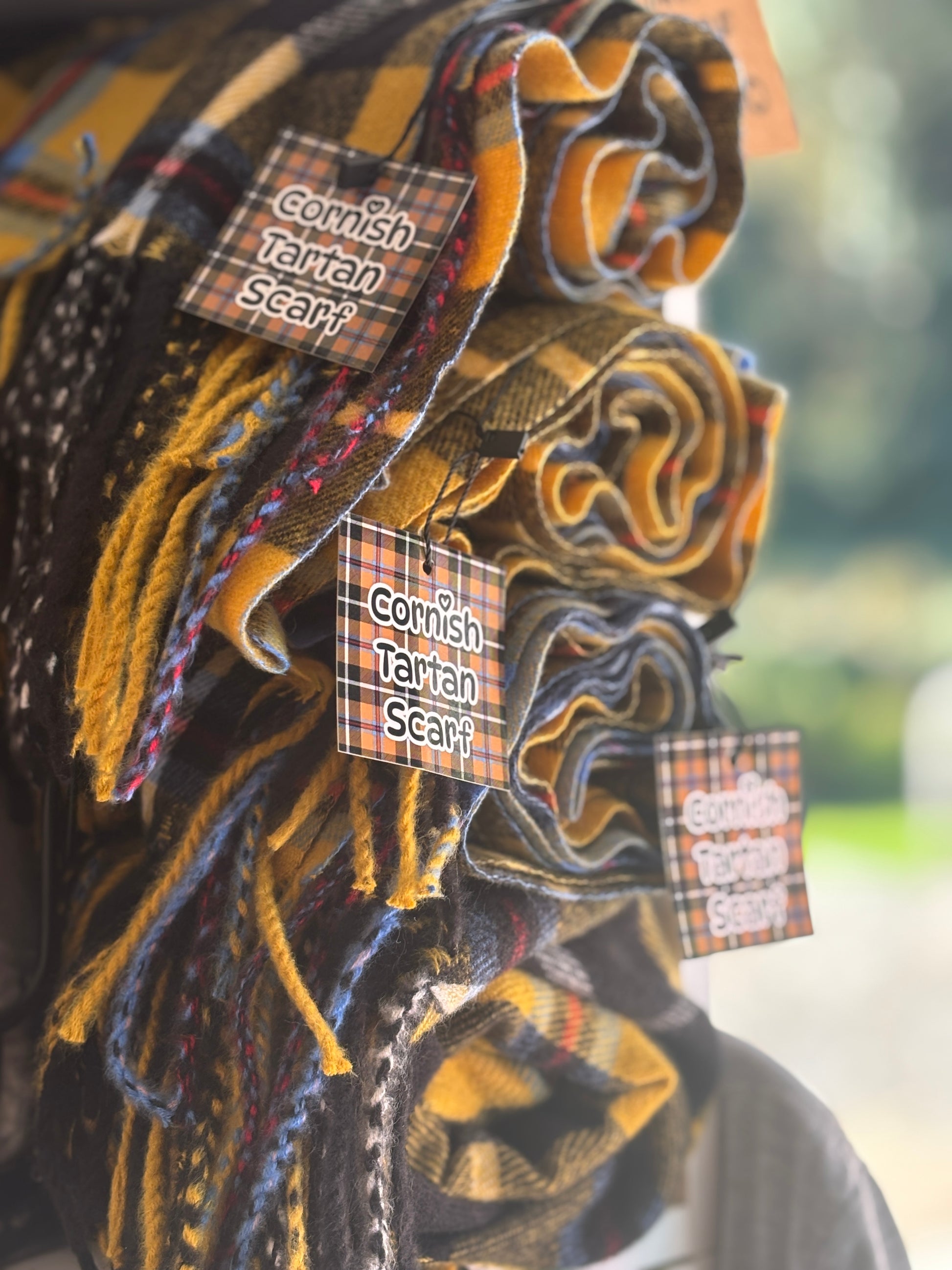 Cornish tartan scarf bundle in vibrant plaid—traditional wool wraps with tags, ideal for cozy coastal gifts and seasonal style