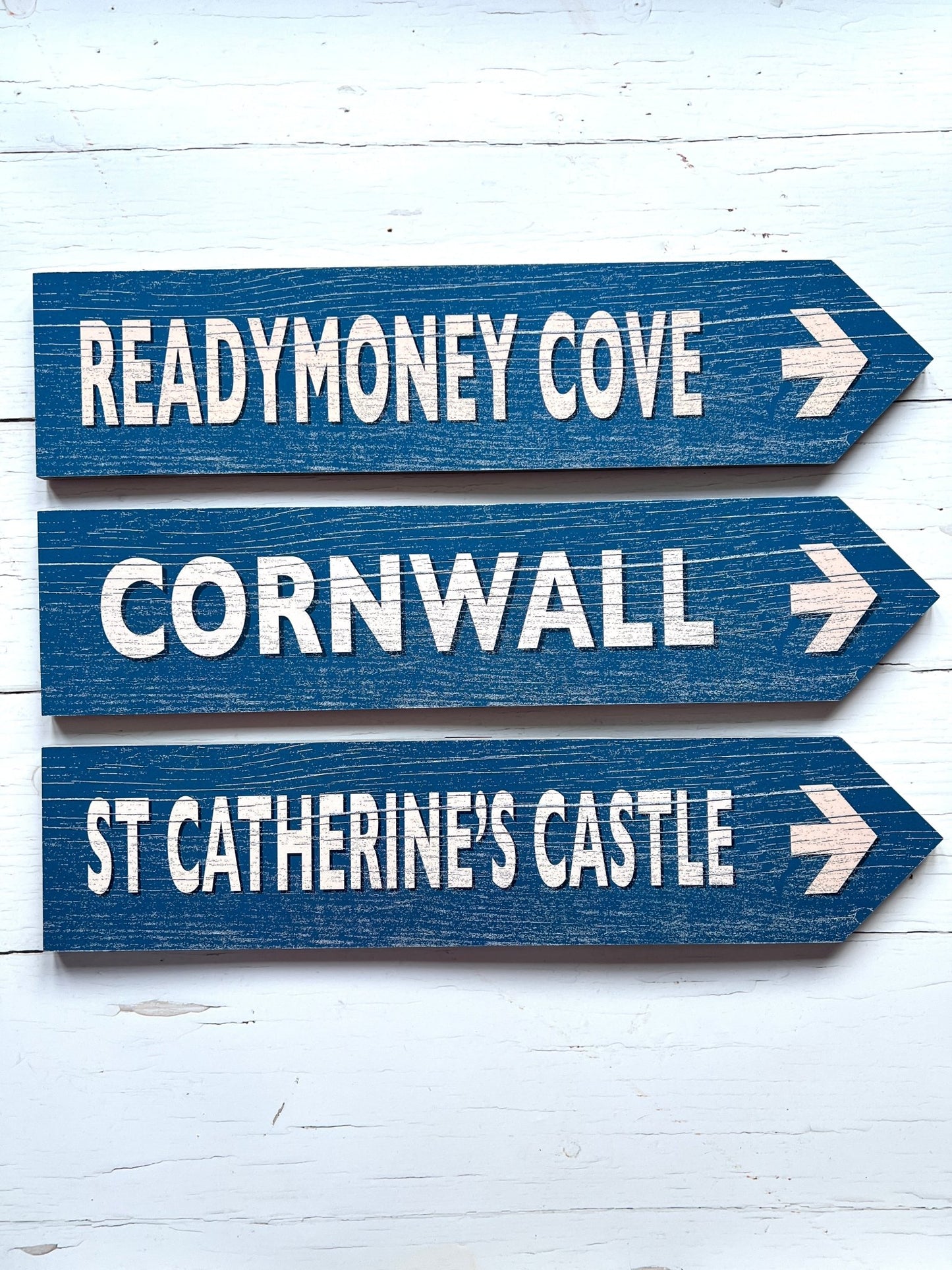 set of three blue Cornwall directional arrow signs to Readymoney Cove and St Catherine's Castle nautical wall art decor