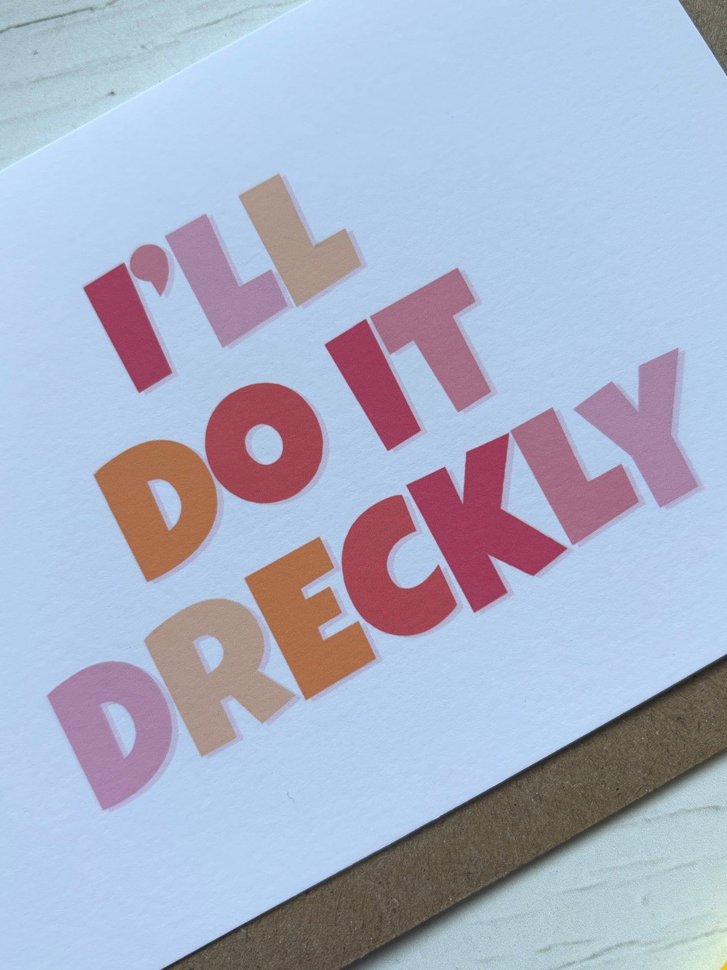 "I'll Do It Dreckly" greeting card closeup funny Cornish dialect slang for soon/shortly bold, colorful typography