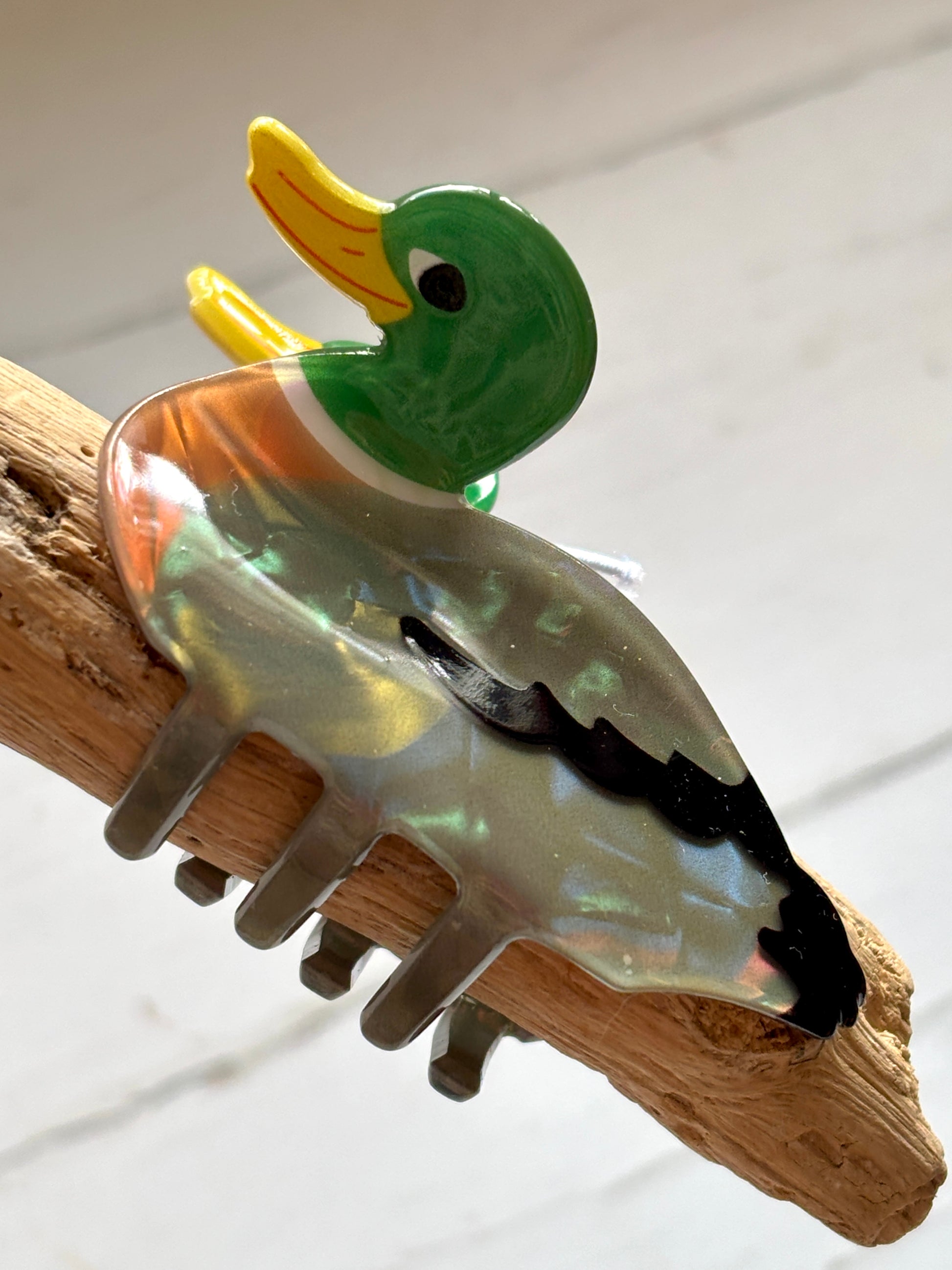 cute duck hair claw clip in glossy green and yellow, retro animal hair accessory with iridescent finish and fun design