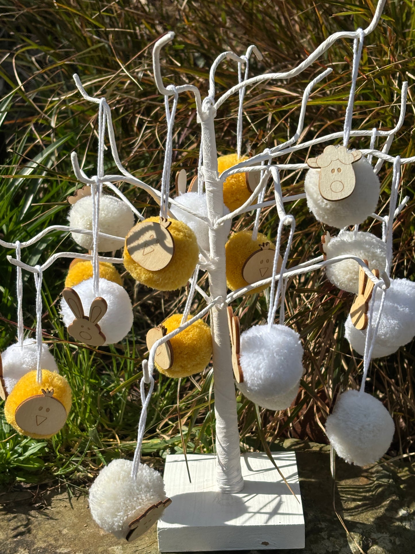 easter pom pom decorations outdoor display - white and yellow tree ornaments with wooden bunny chick lamb