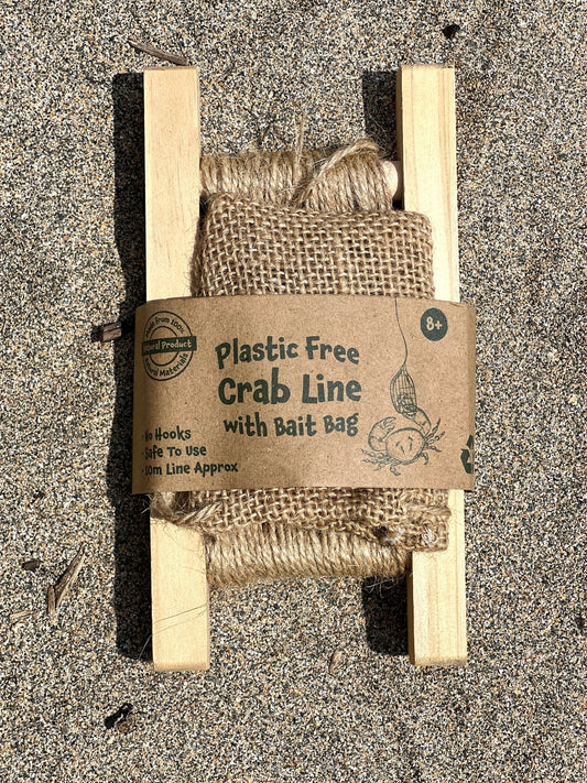 plastic-free wooden crabbing line with natural jute bait bag - sustainable beach fishing equipment on sand